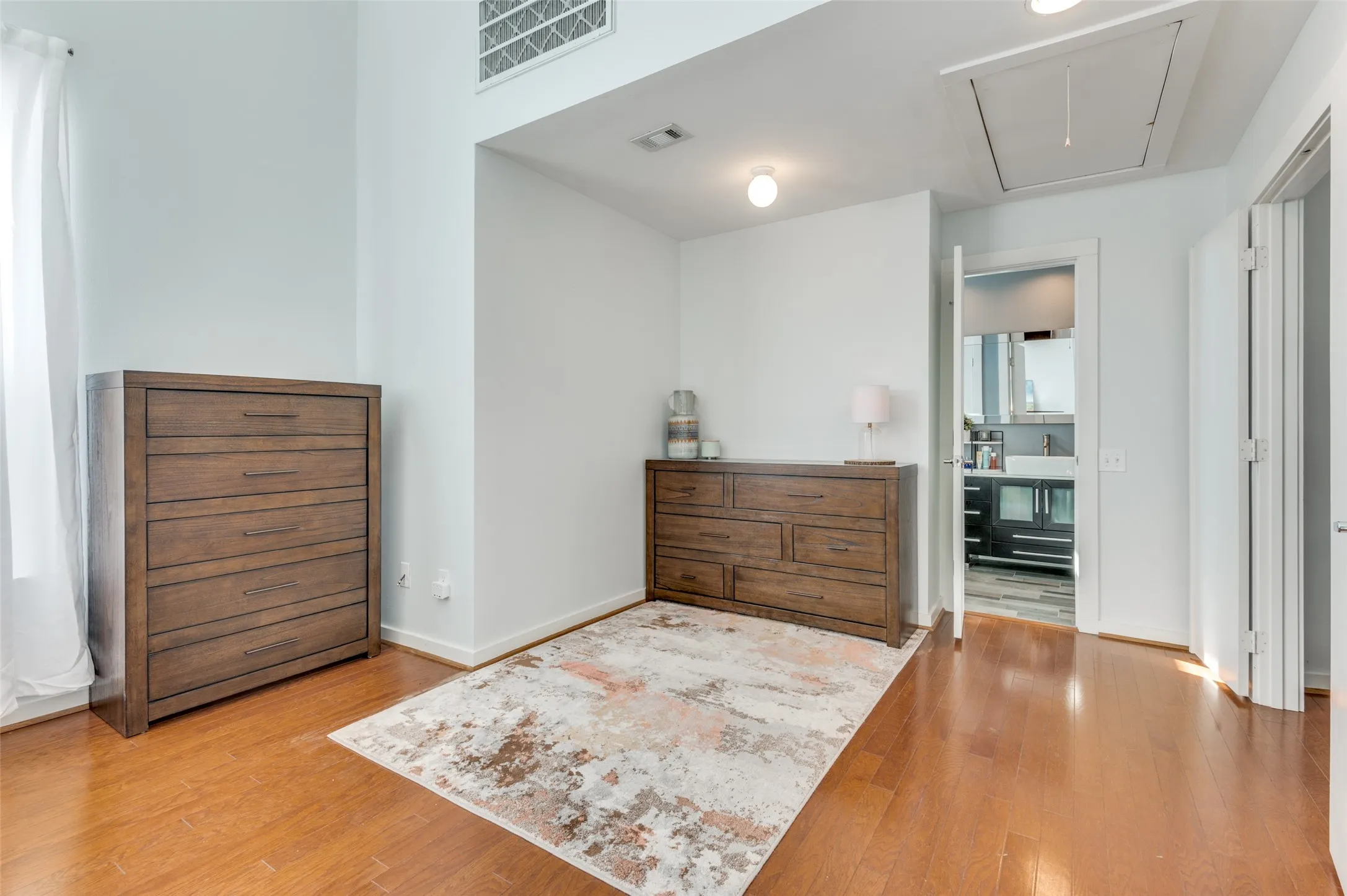 Primary suite featuring soaring ceilings, walk in closet, and spa inspired bath