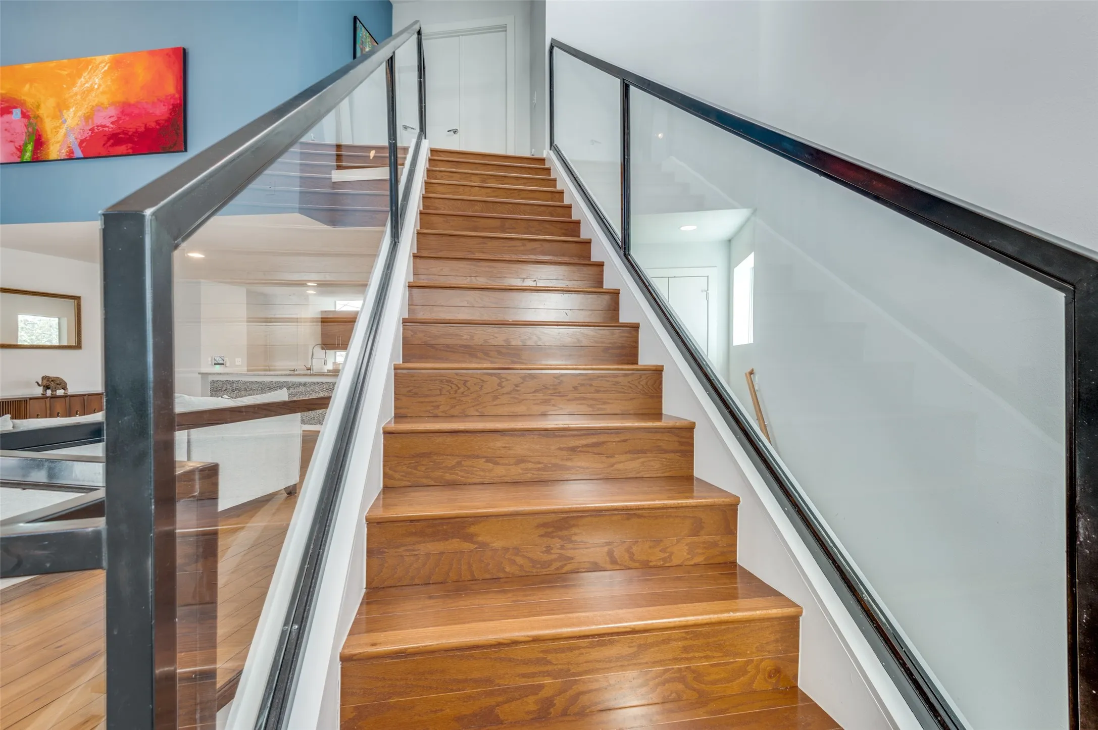 Striking floating staircase with glass bannisters and modern architectural design