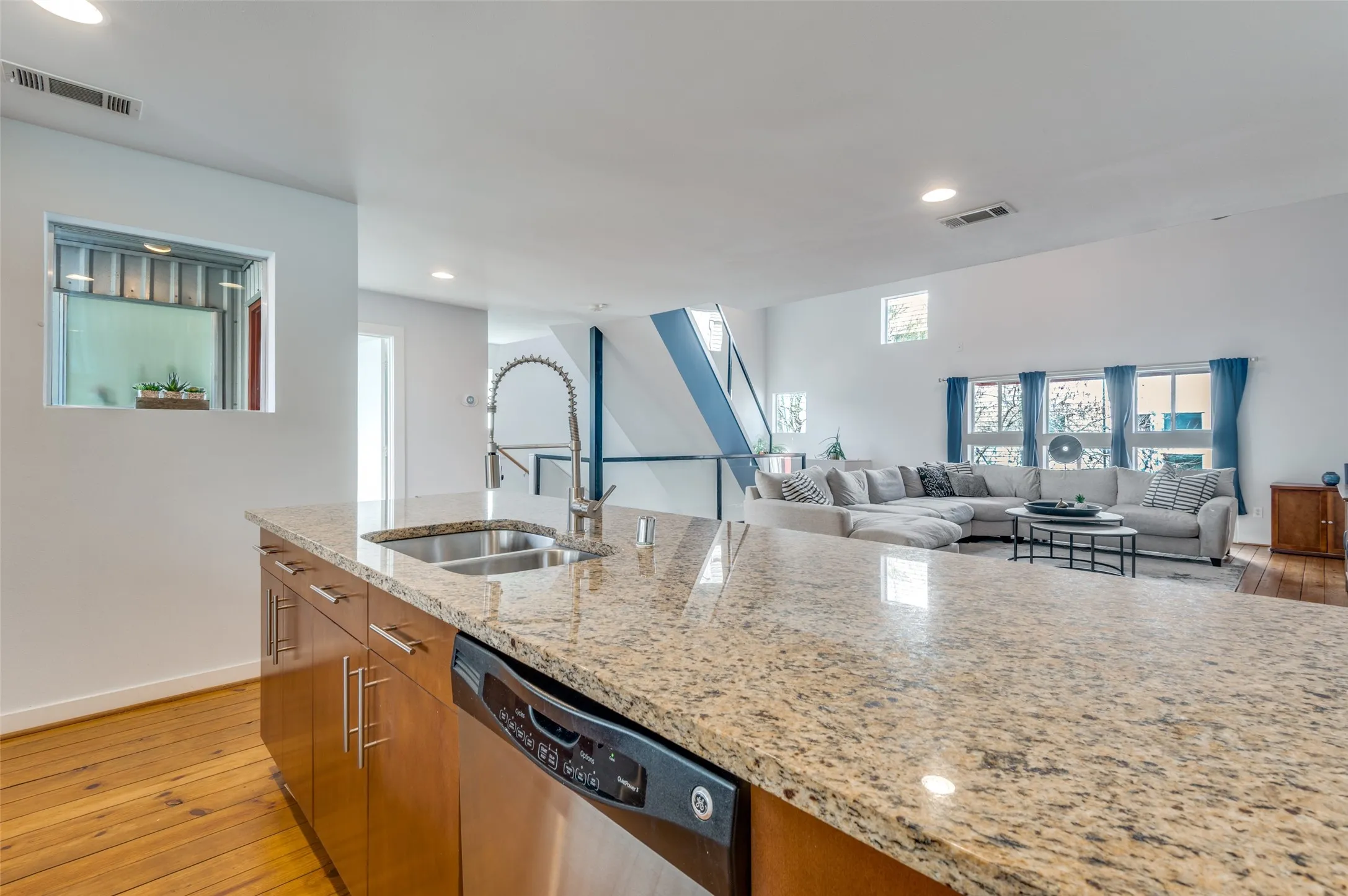 Chef’s kitchen with granite countertops, gas range, and breakfast bar seating