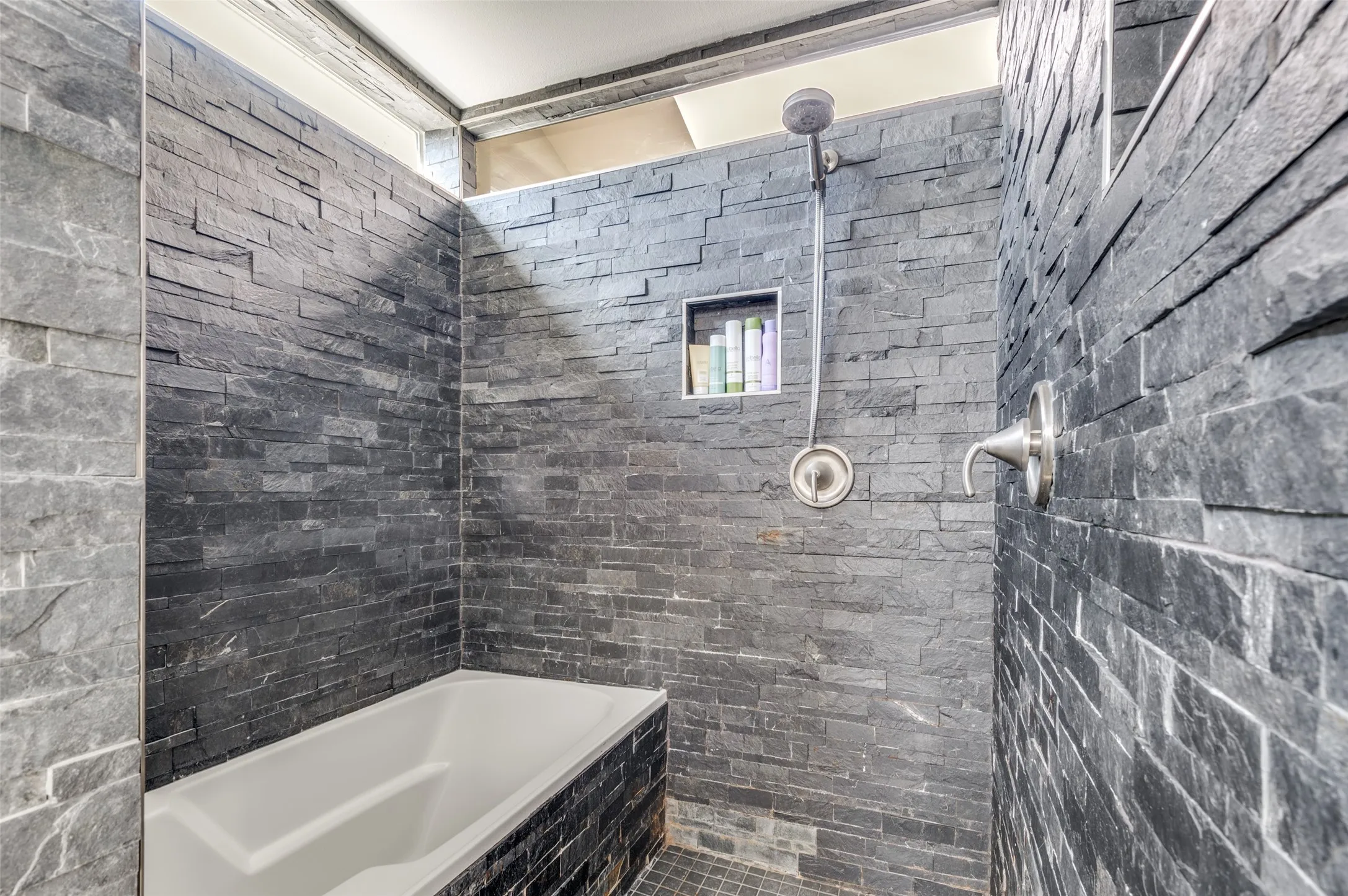 Renovated primary bath with dual sinks and an impressive wet room with soaking tub and shower