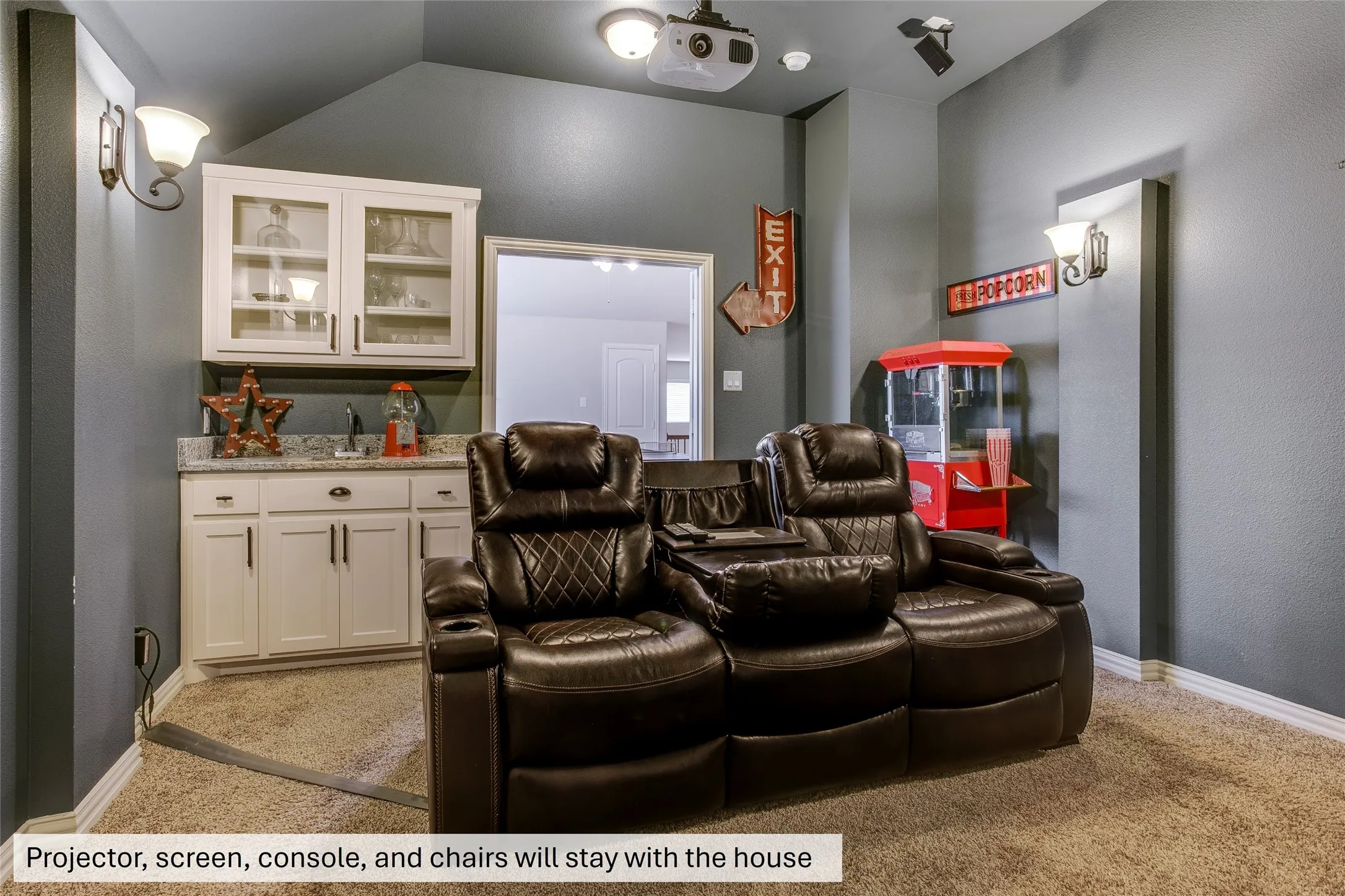 Projector, screen, console, and chairs will stay with the house.