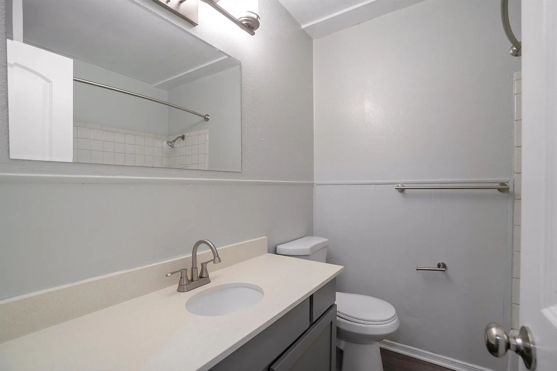 Bathroom featuring a vanity with an integrated sink, light-toned countertop, and brushed nickel faucet