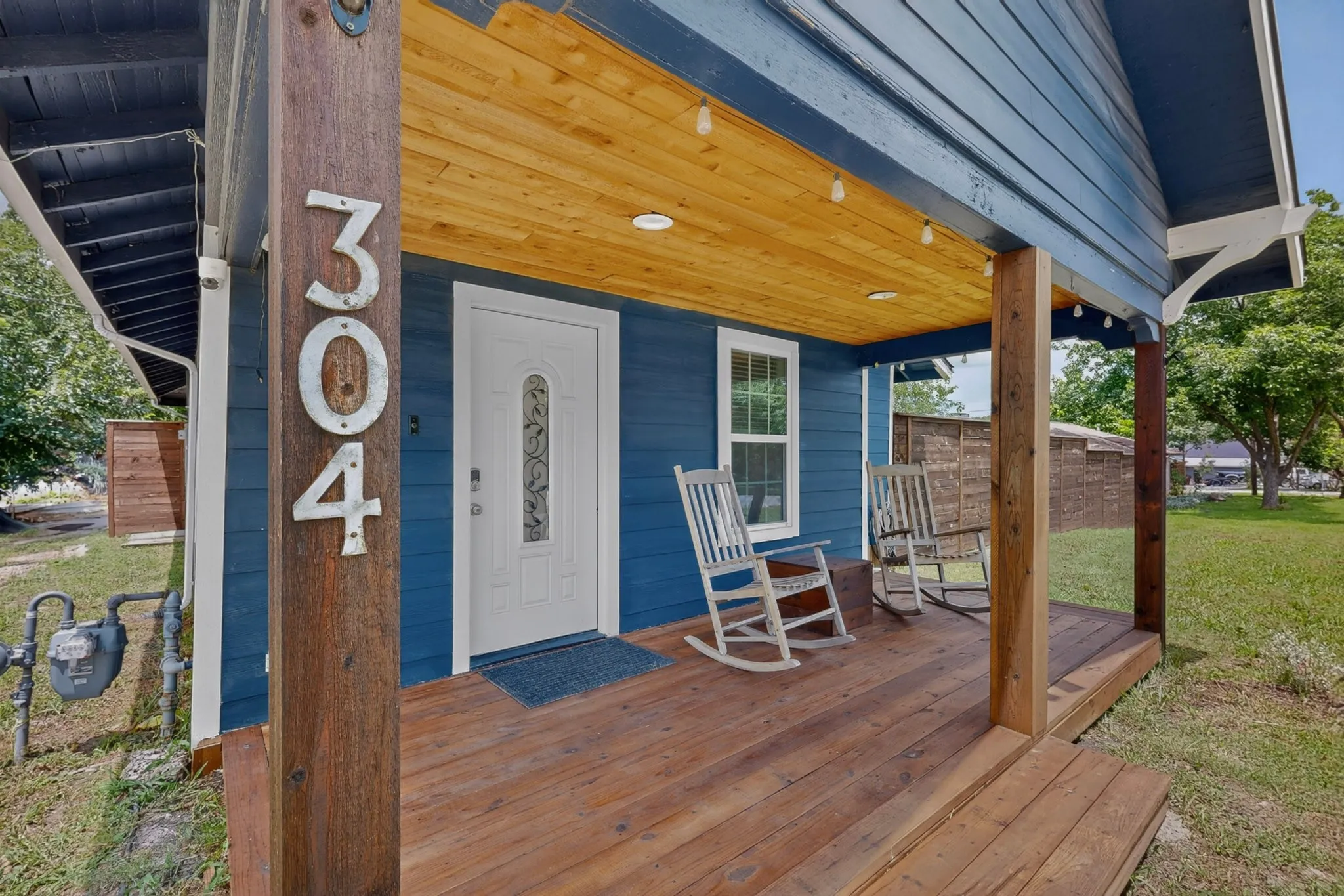 Spacious open-concept living area featuring wood-finish flooring, recessed lighting, and multiple ceiling fans