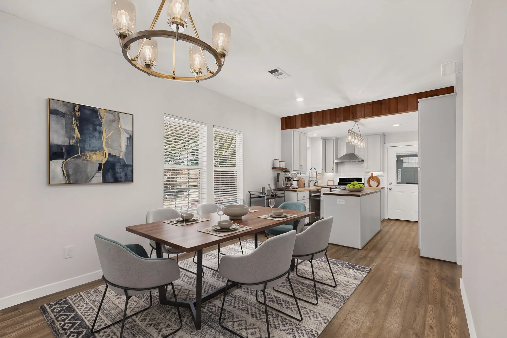 Open-concept living area with wood-finish flooring, a contemporary chandelier, and recessed lighting