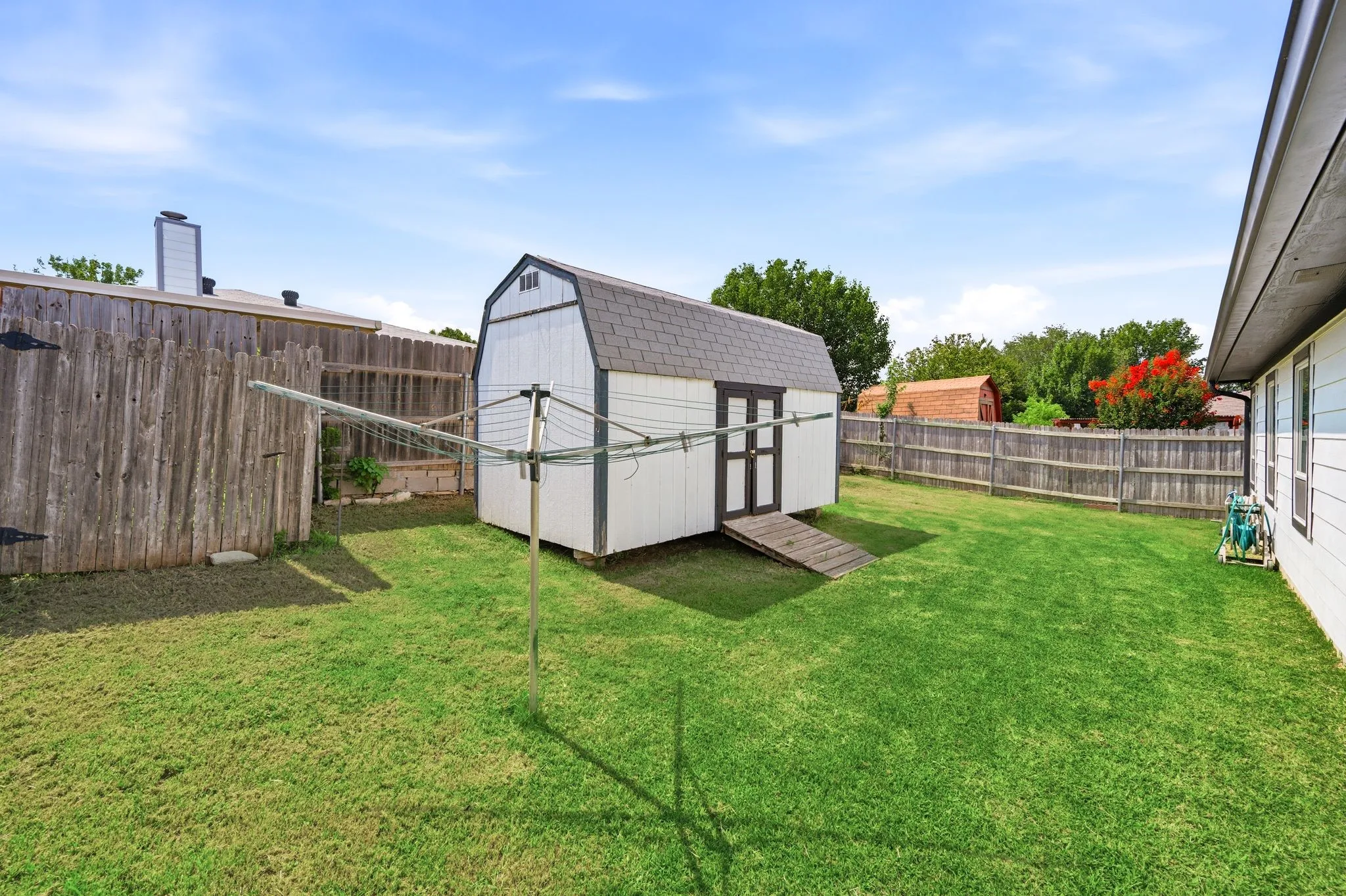 Backyard with storage bldg and clothes line