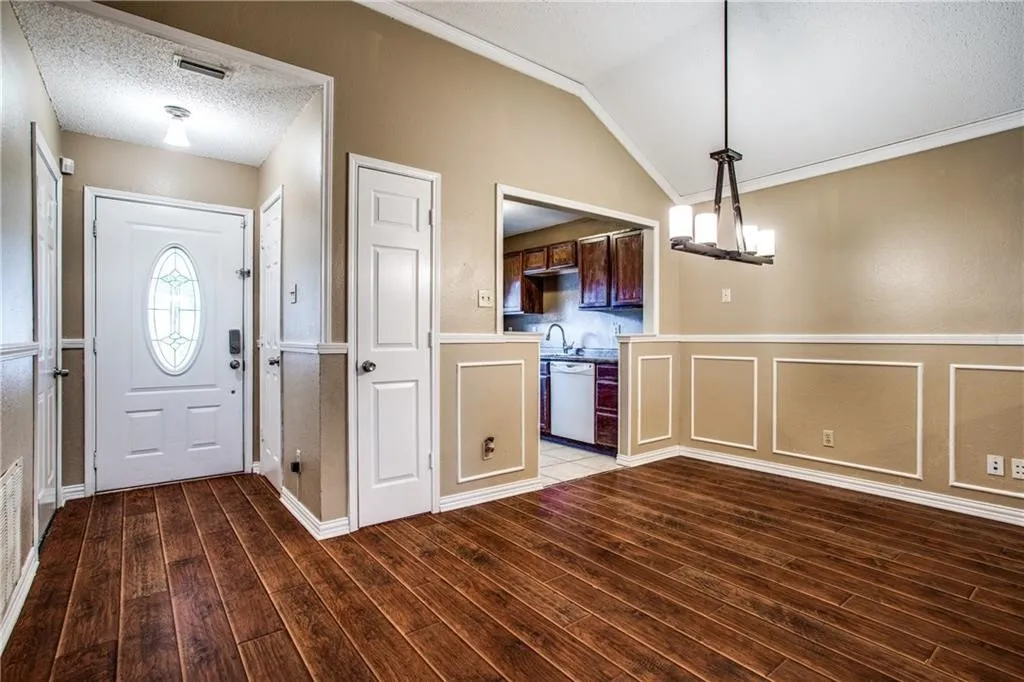 Entryway and dining area featuring wood-finish flooring