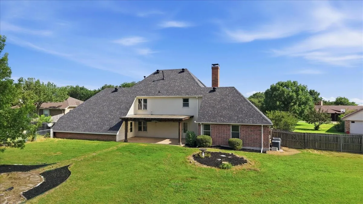 Expansive property with substantial green space, mature trees, and an extended driveway