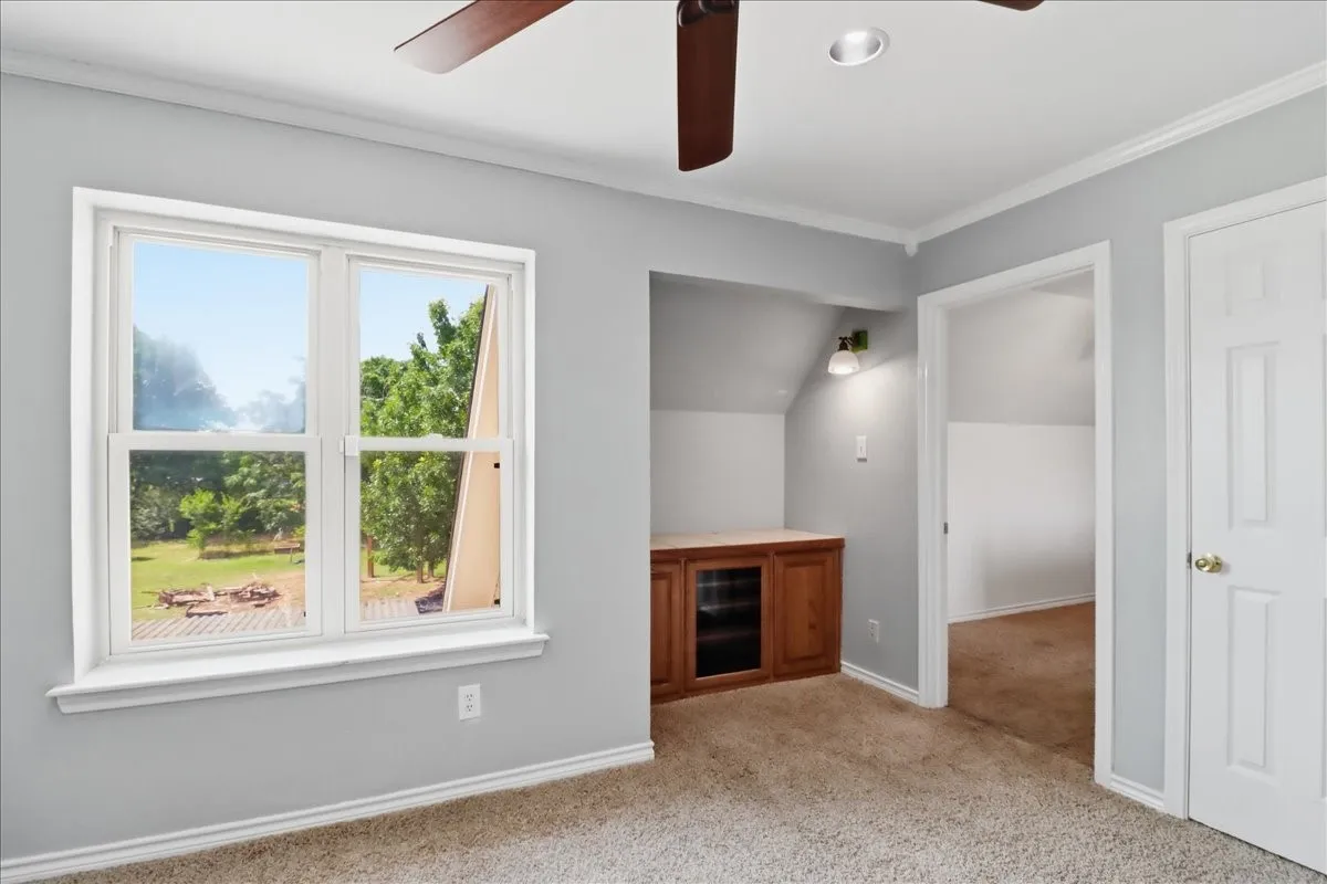 Second bedroom with sloped ceilings and recessed window