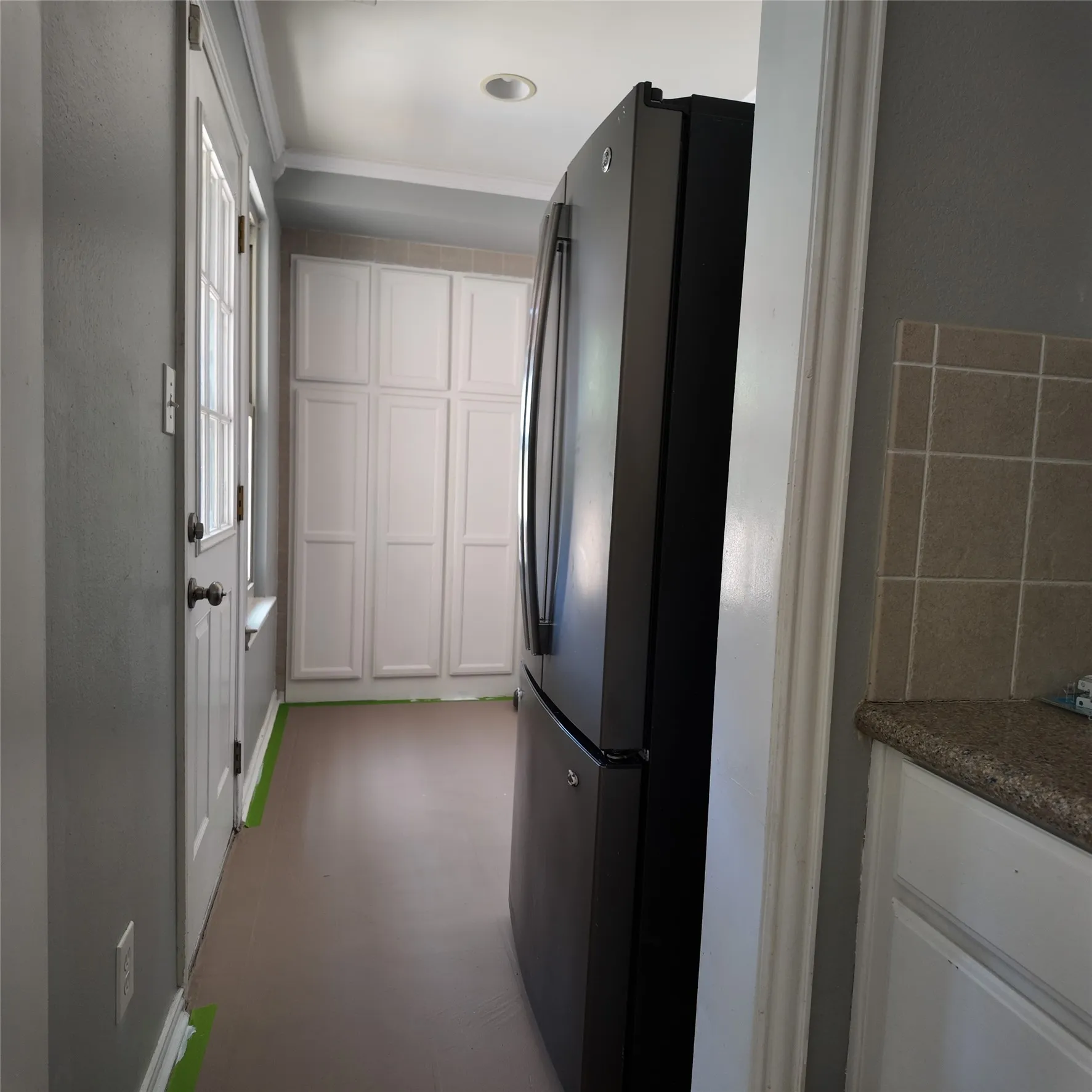 laundry area featuring overhead shelving, and lighting