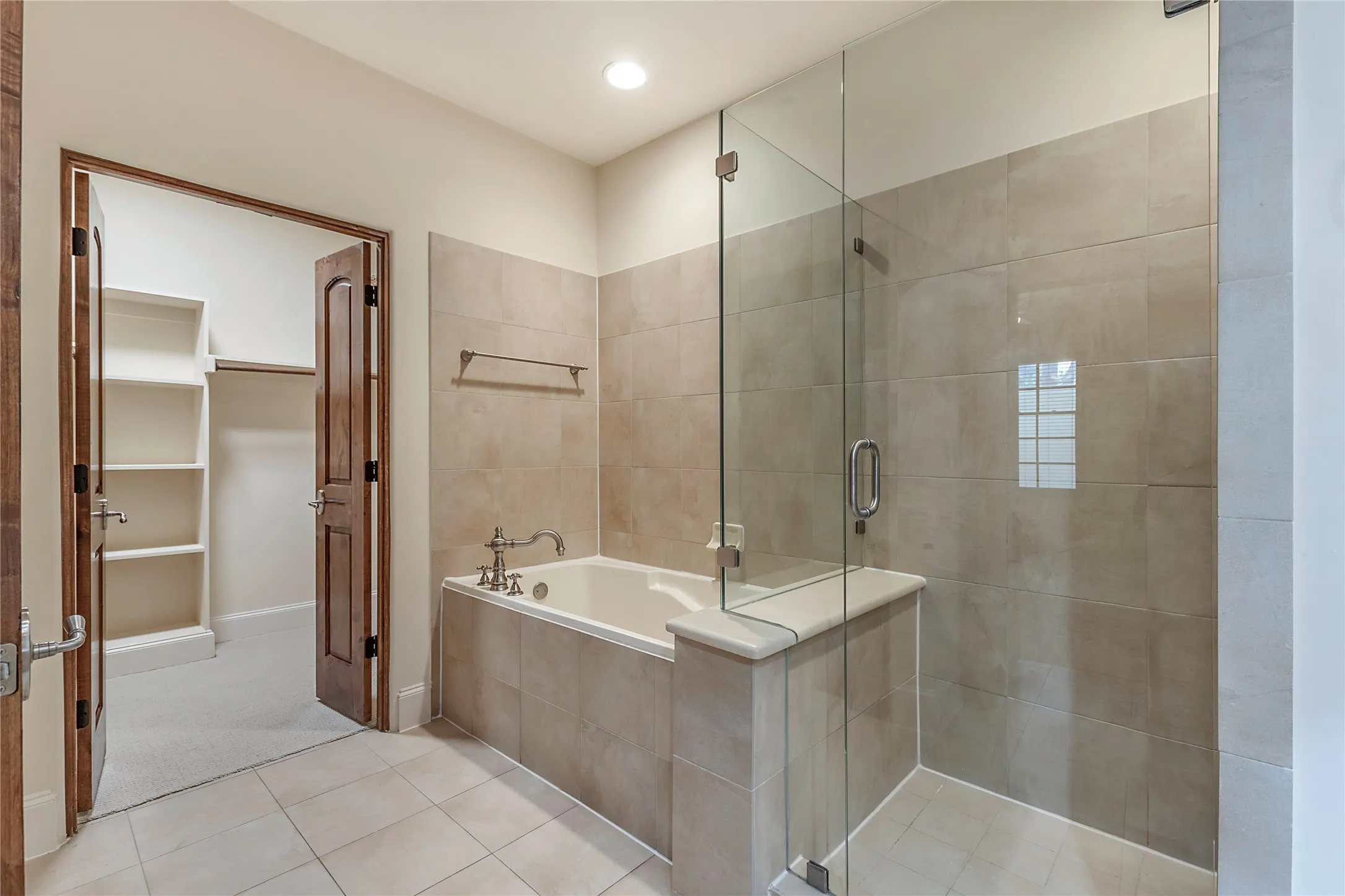 Bathroom featuring tile patterned flooring and independent shower and bath