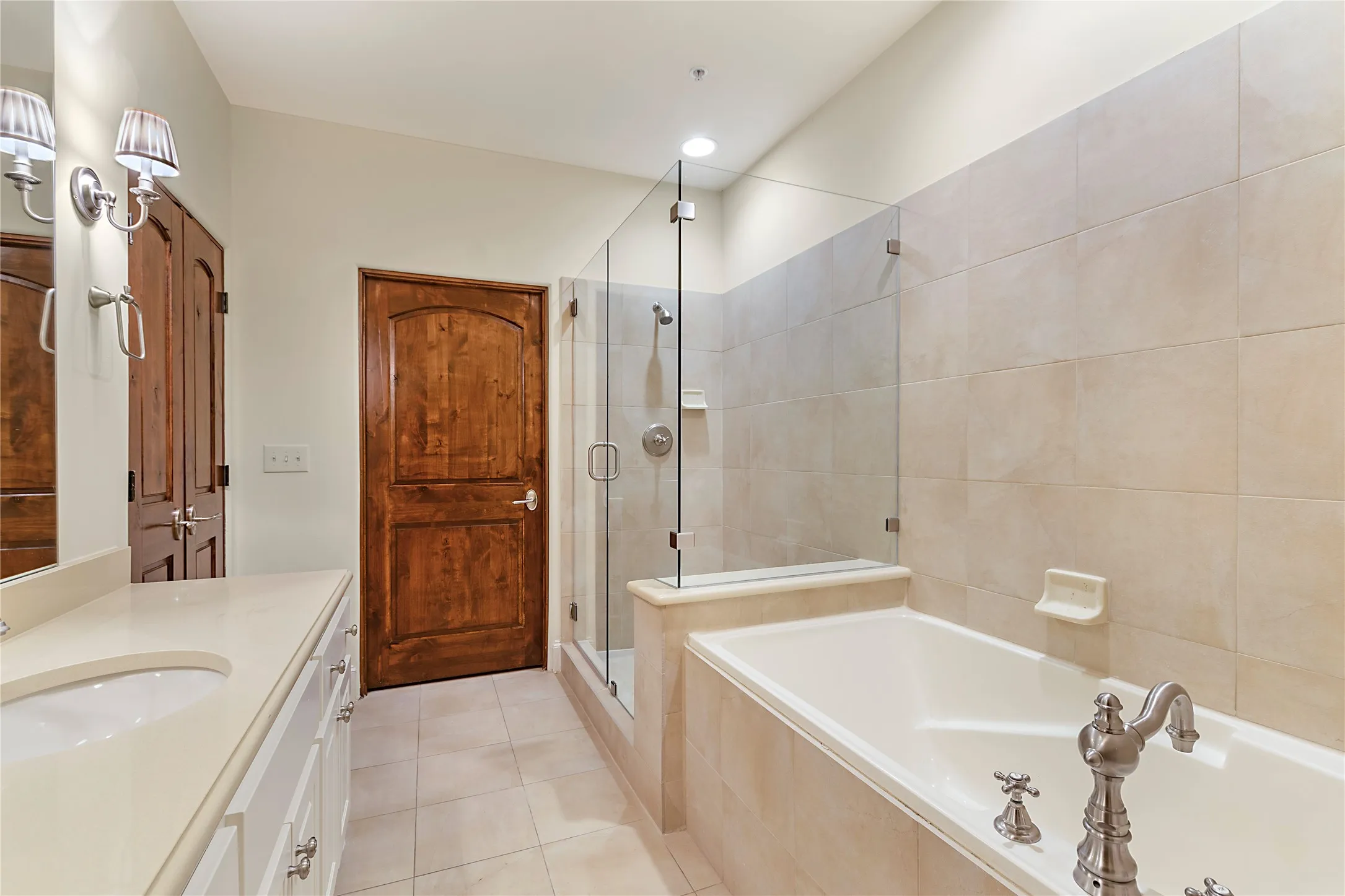 Bathroom with independent shower and bath, tile patterned flooring, and vanity