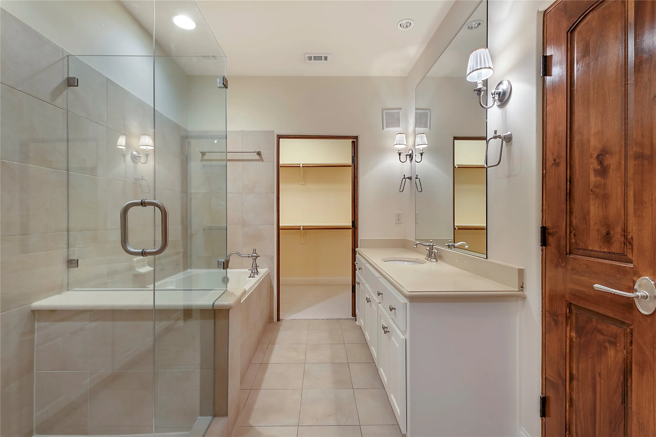 Bathroom featuring tile patterned floors, independent shower and bath, and vanity