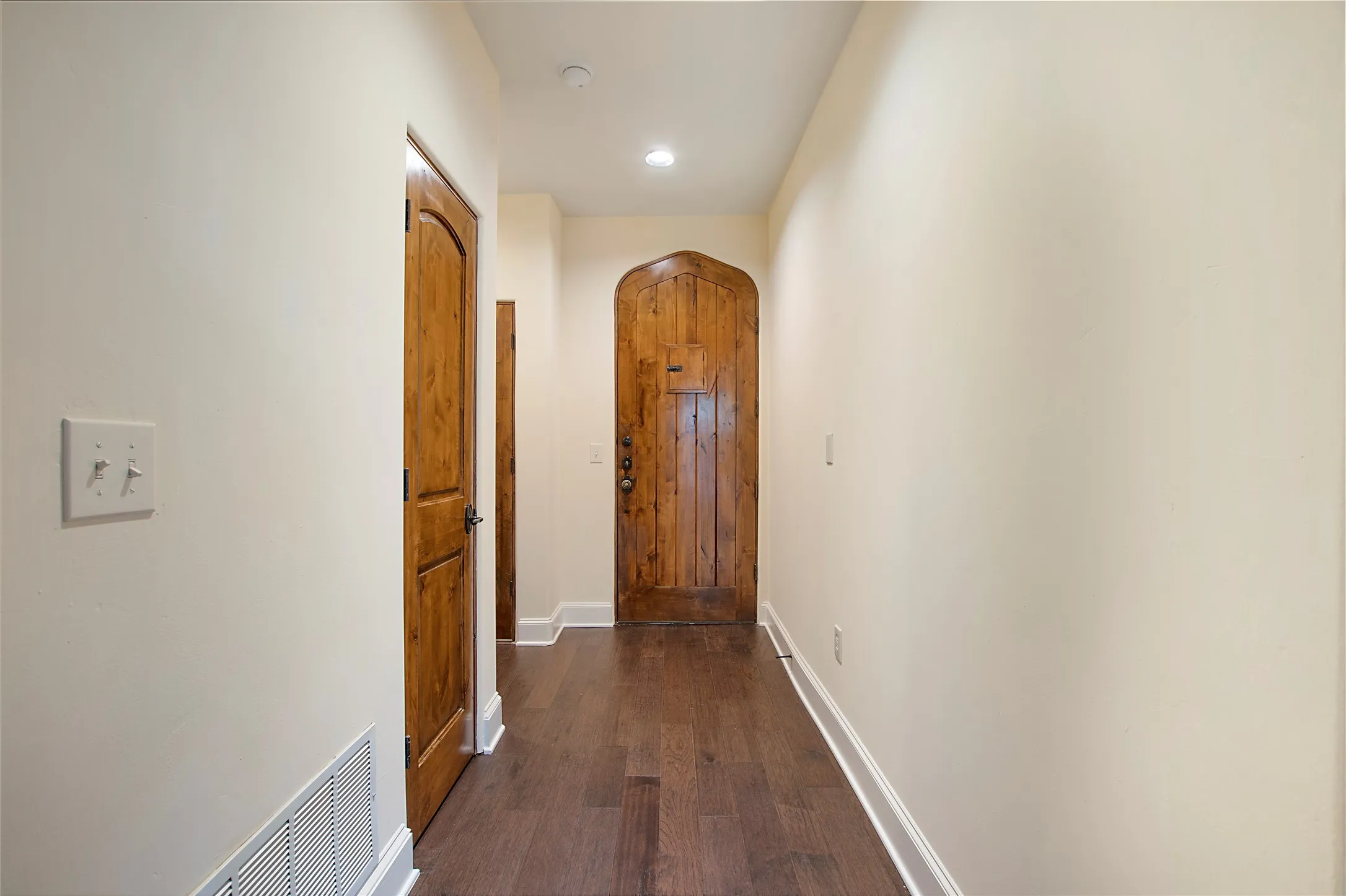 Corridor featuring dark wood-type flooring