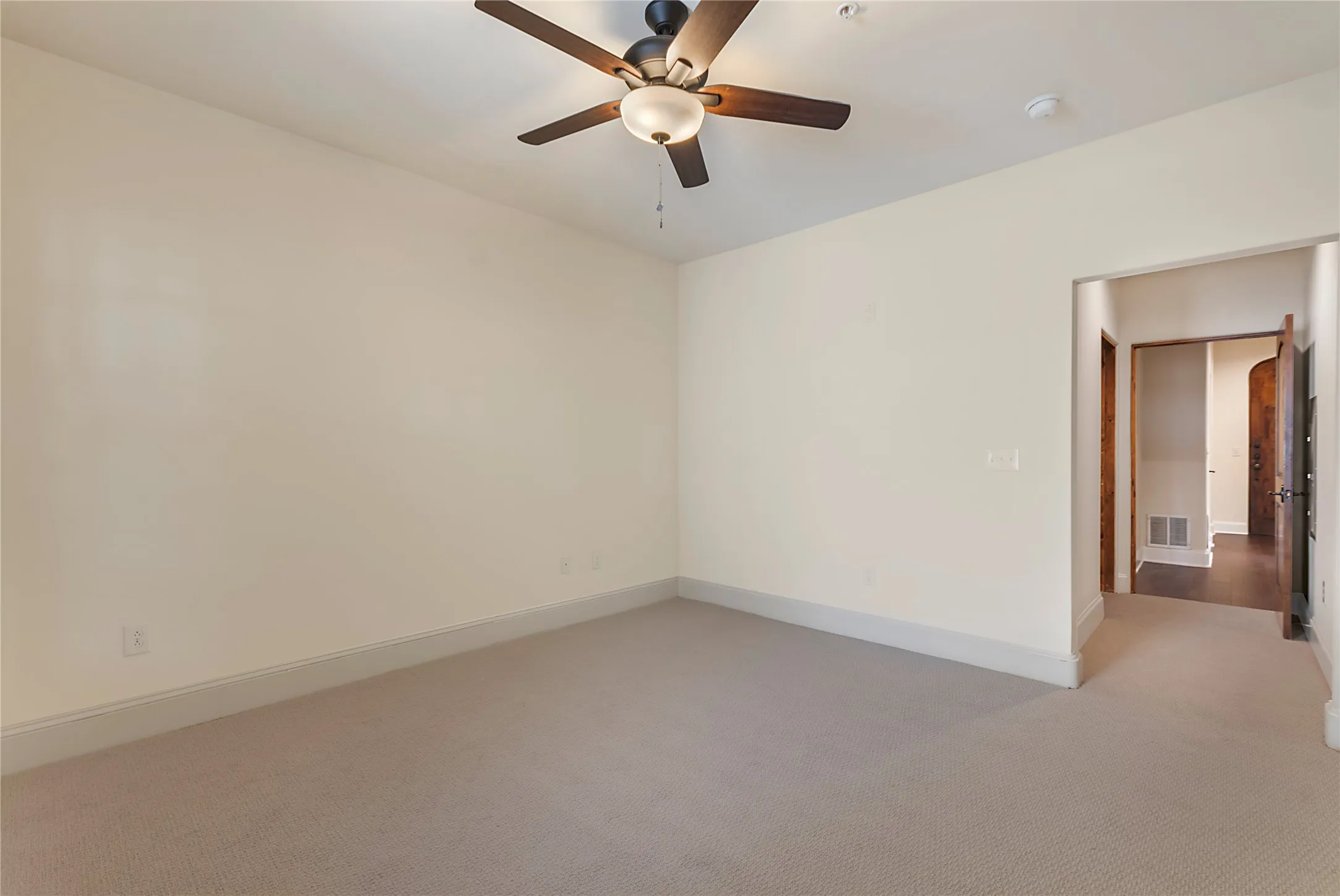 Spare room with ceiling fan and light colored carpet