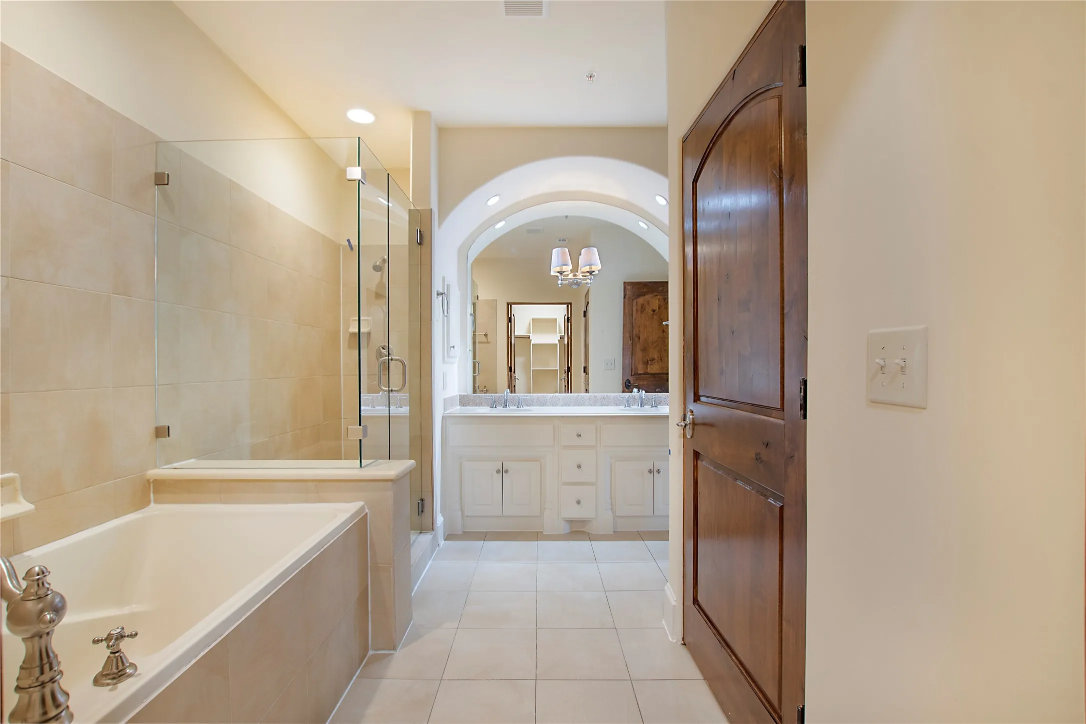 Bathroom featuring tile patterned floors, independent shower and bath, and vanity