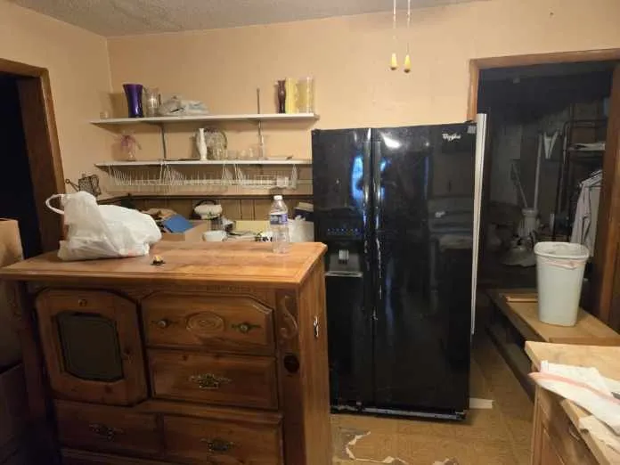 Black side-by-side refrigerator featuring an external ice and water dispenser