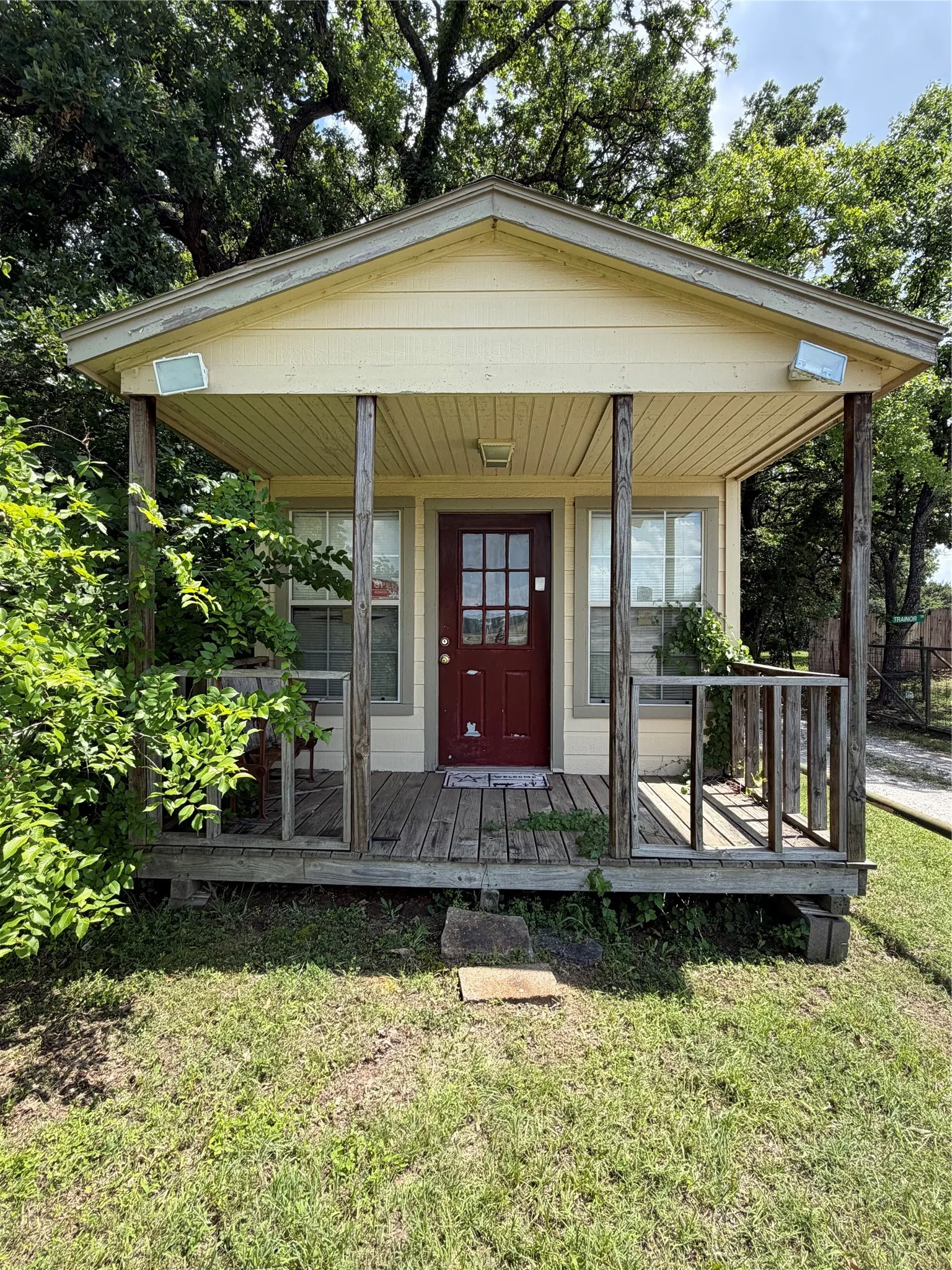 Tiny home with road front footage and  electric in place located at the front of the long driveway.