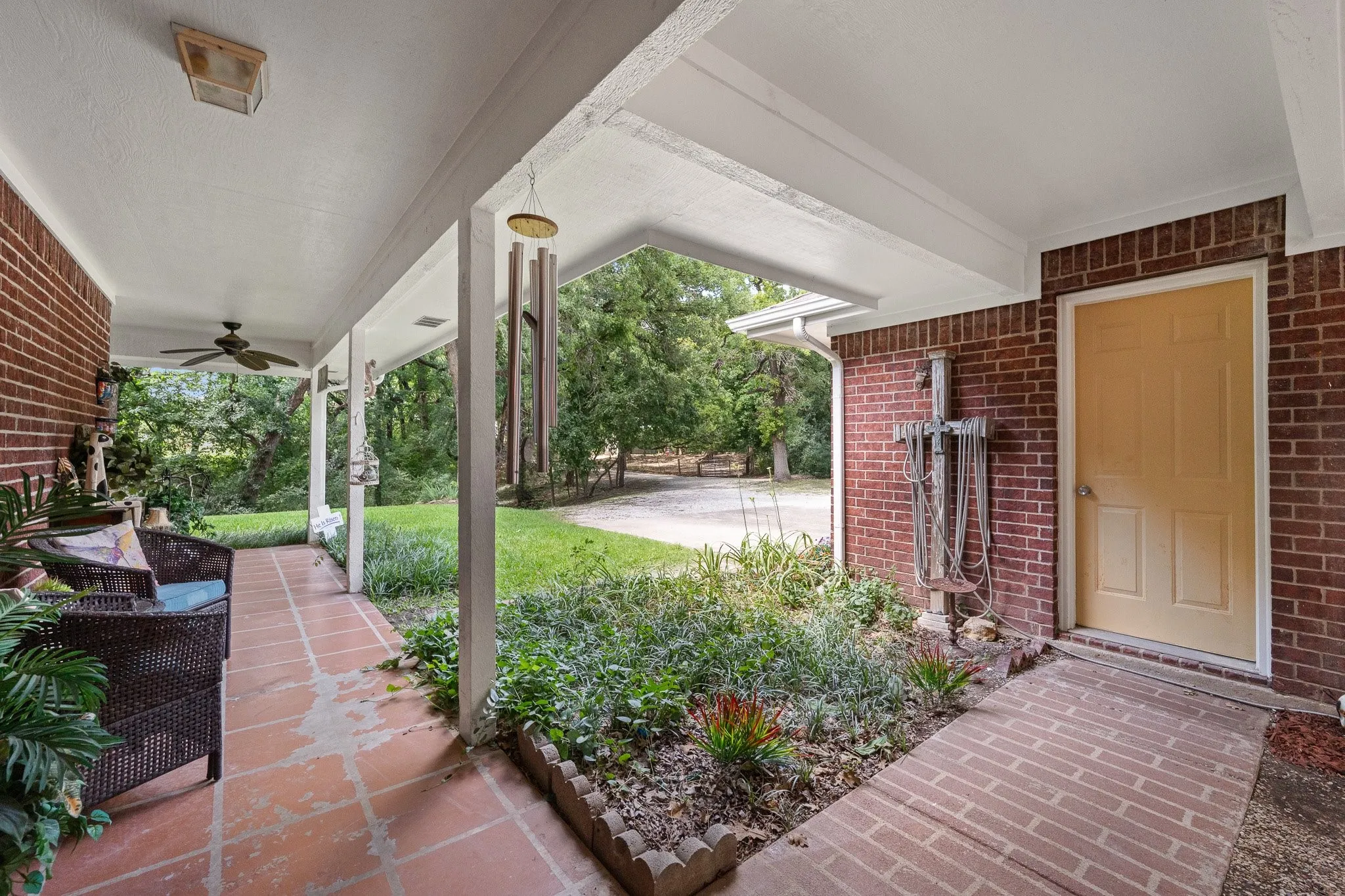 View of detached garage with convered walkway and courtyard area between garage and home.