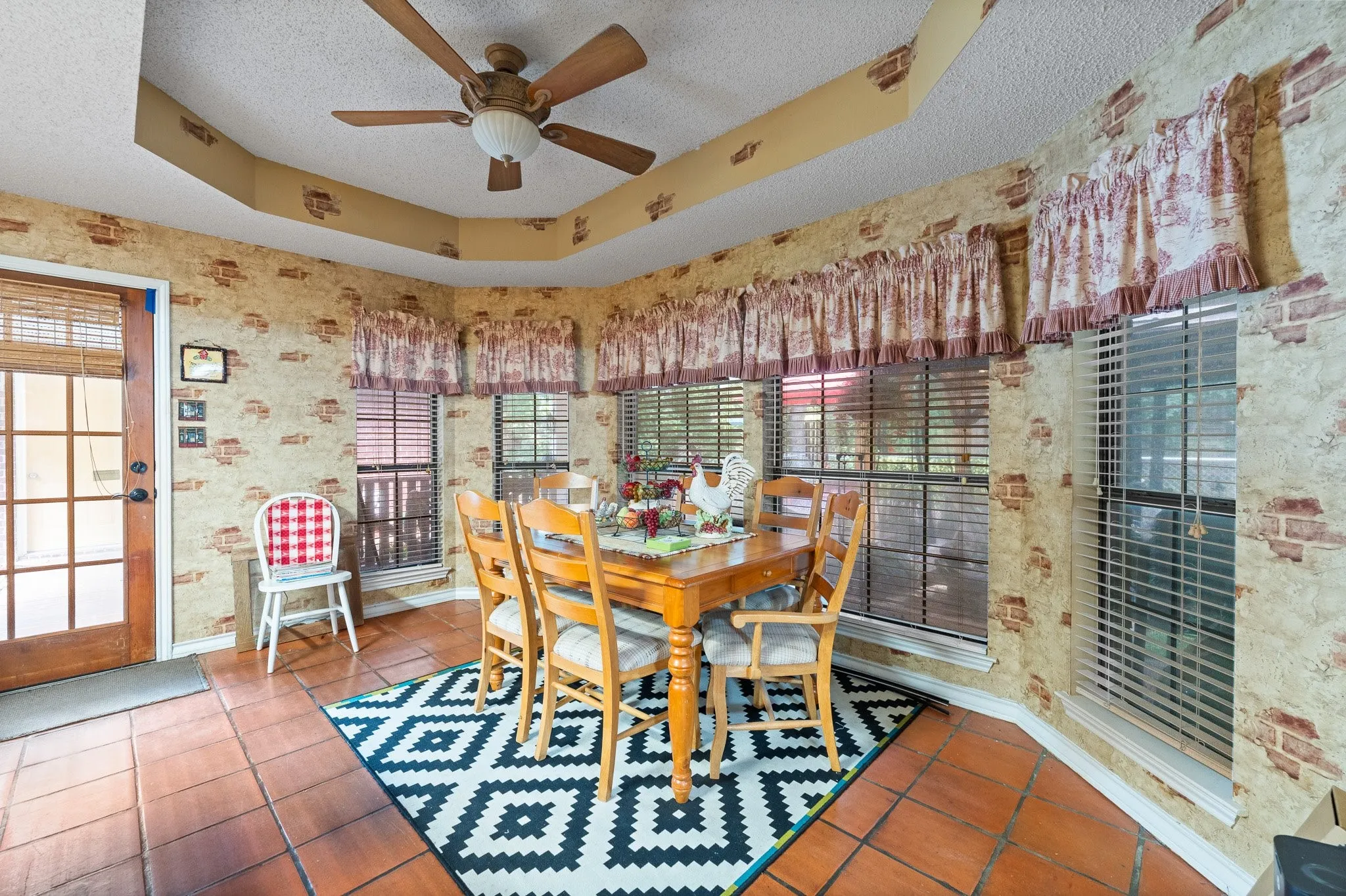 Eat in dining area featuring a bay window with backyard views