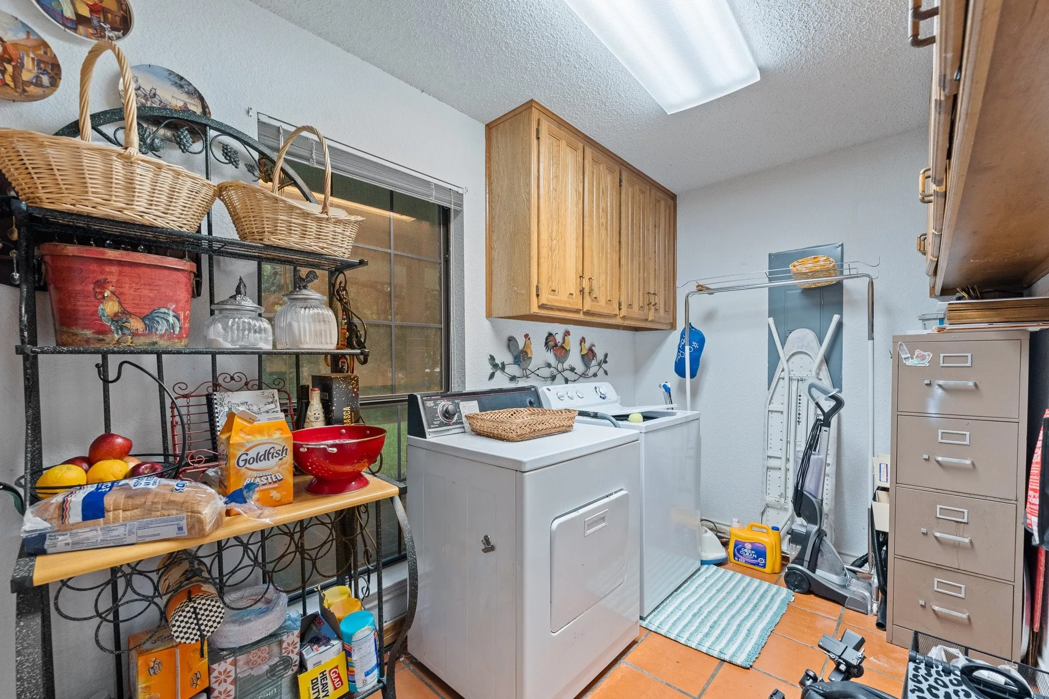 Large laundry room with plenty of space of storage and a pantry area behind the door