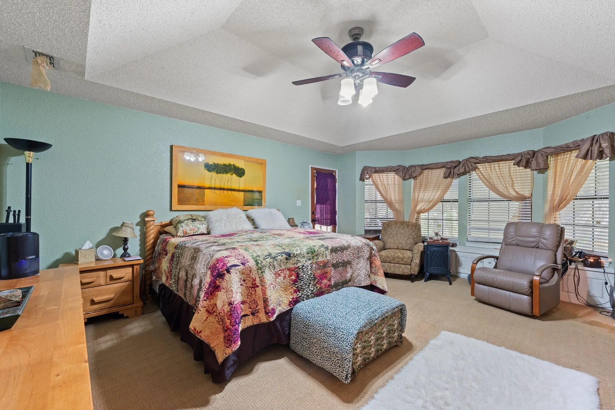 Owners suite with a sitting area, bay window, and door to back porch!