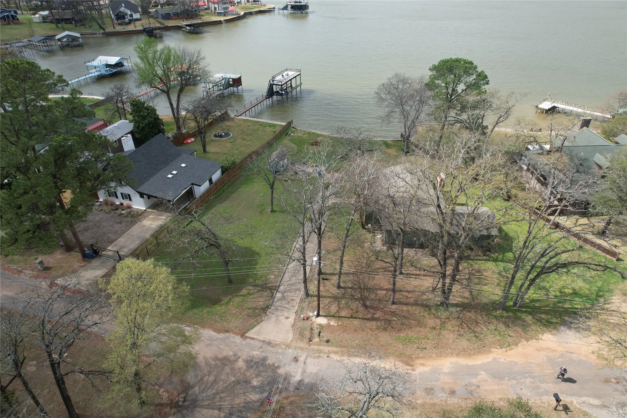 Waterfront property featuring 101'+- of extensive shoreline, mature trees, and a paved driveway with great bay location with HUGE view to the CEDAR CREEK LAKE main body of OPEN WATER VIEWS