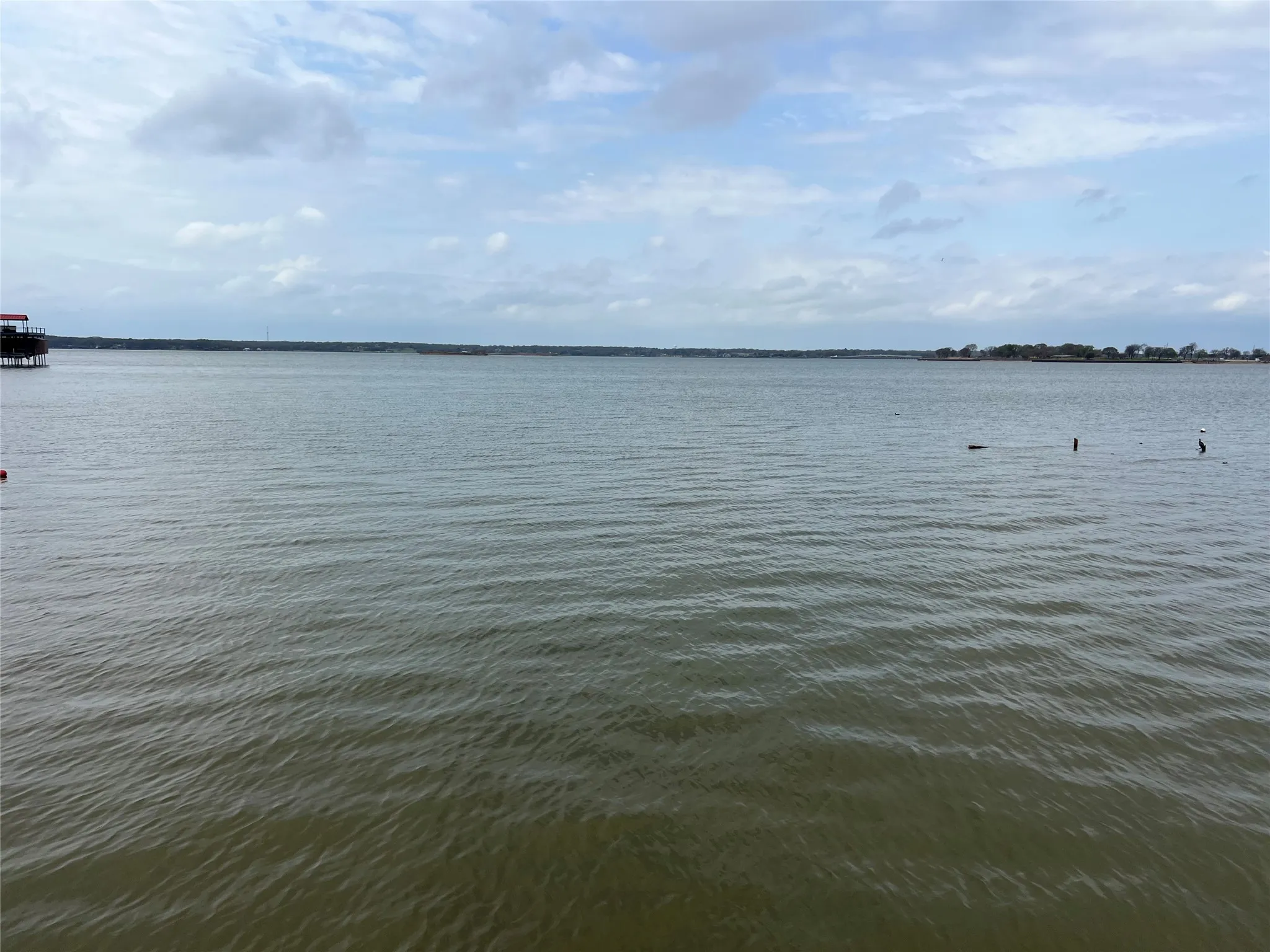 Lake view of OPPORTUNITY! Expansive waterfront view with a distant shoreline