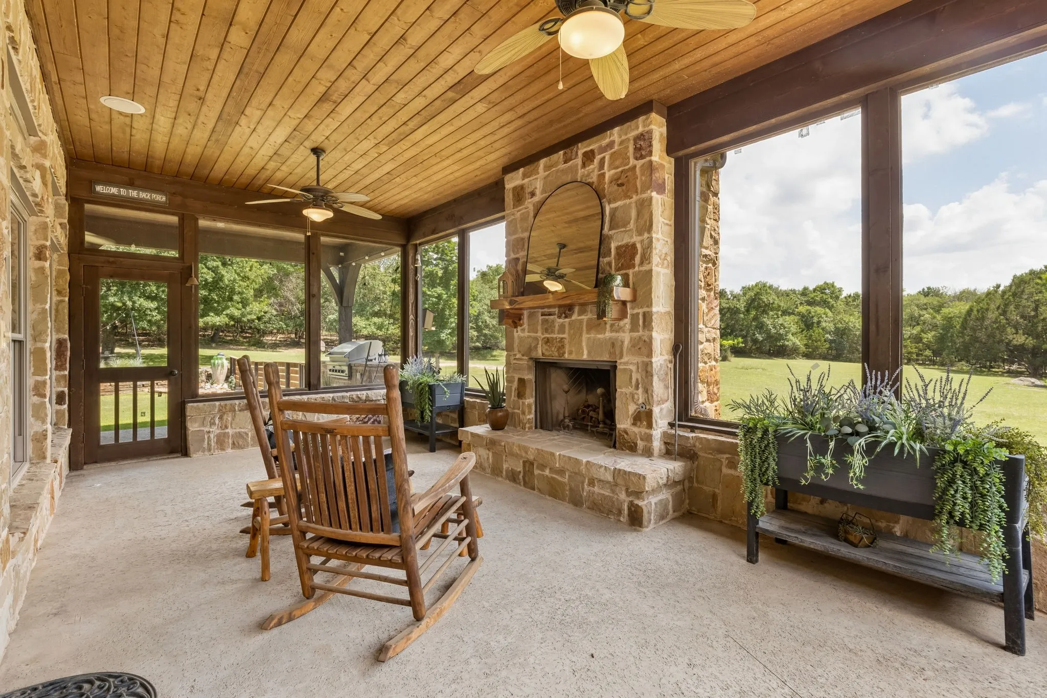Screened patio area with stone fireplace