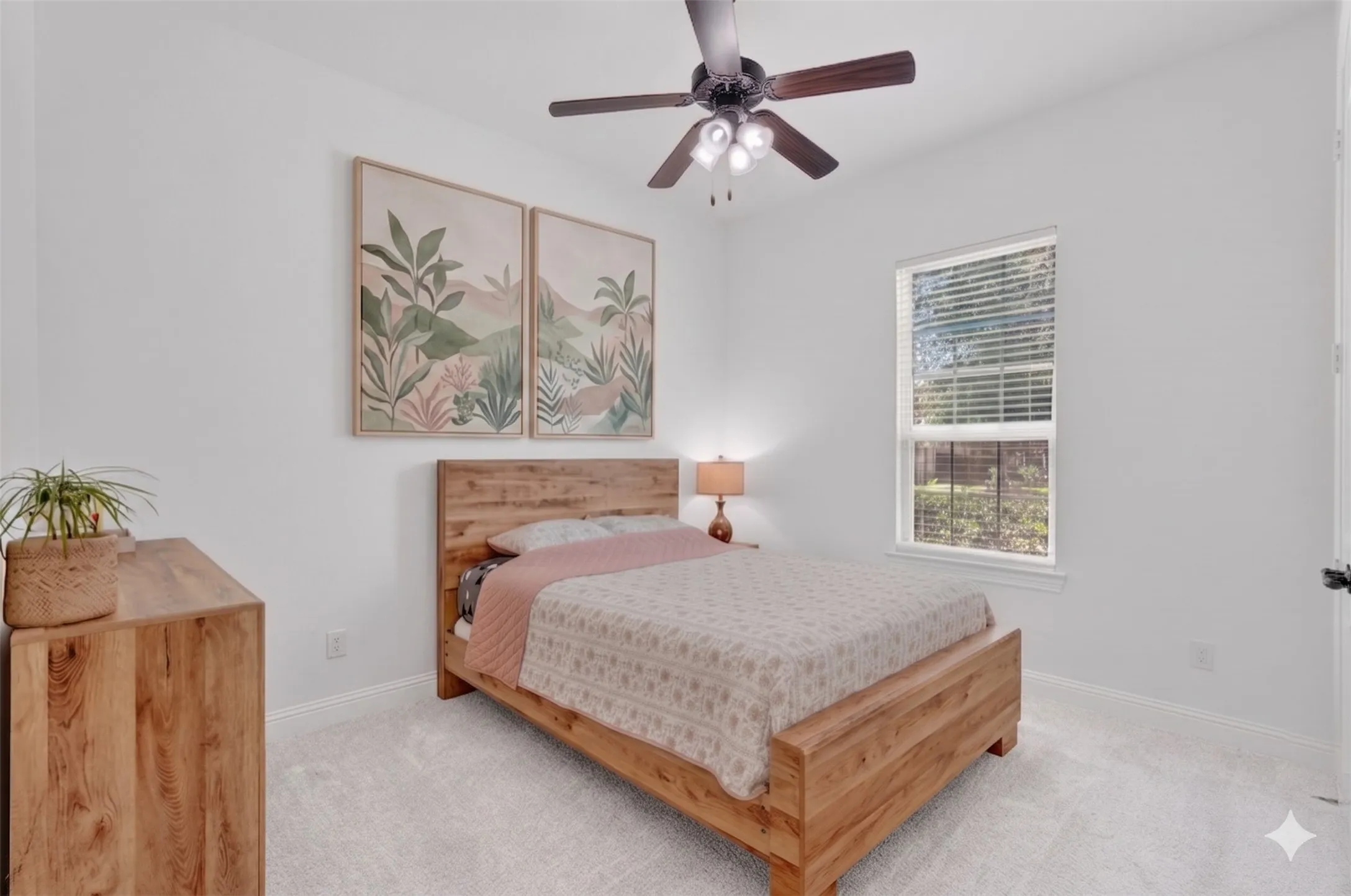 Bright room featuring light-toned carpet, a ceiling fan with integrated lighting, and a single window with blinds