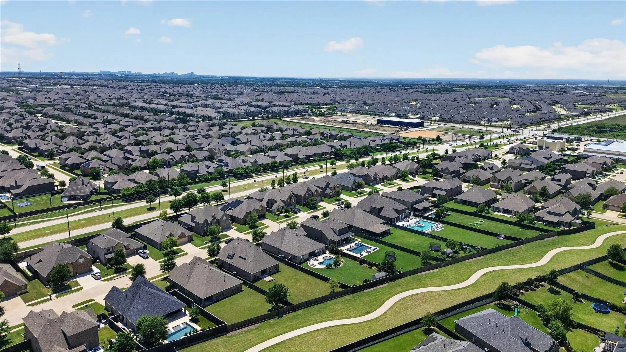 Expansive residential neighborhood featuring numerous single-family homes with pitched roofs and private fenced yards