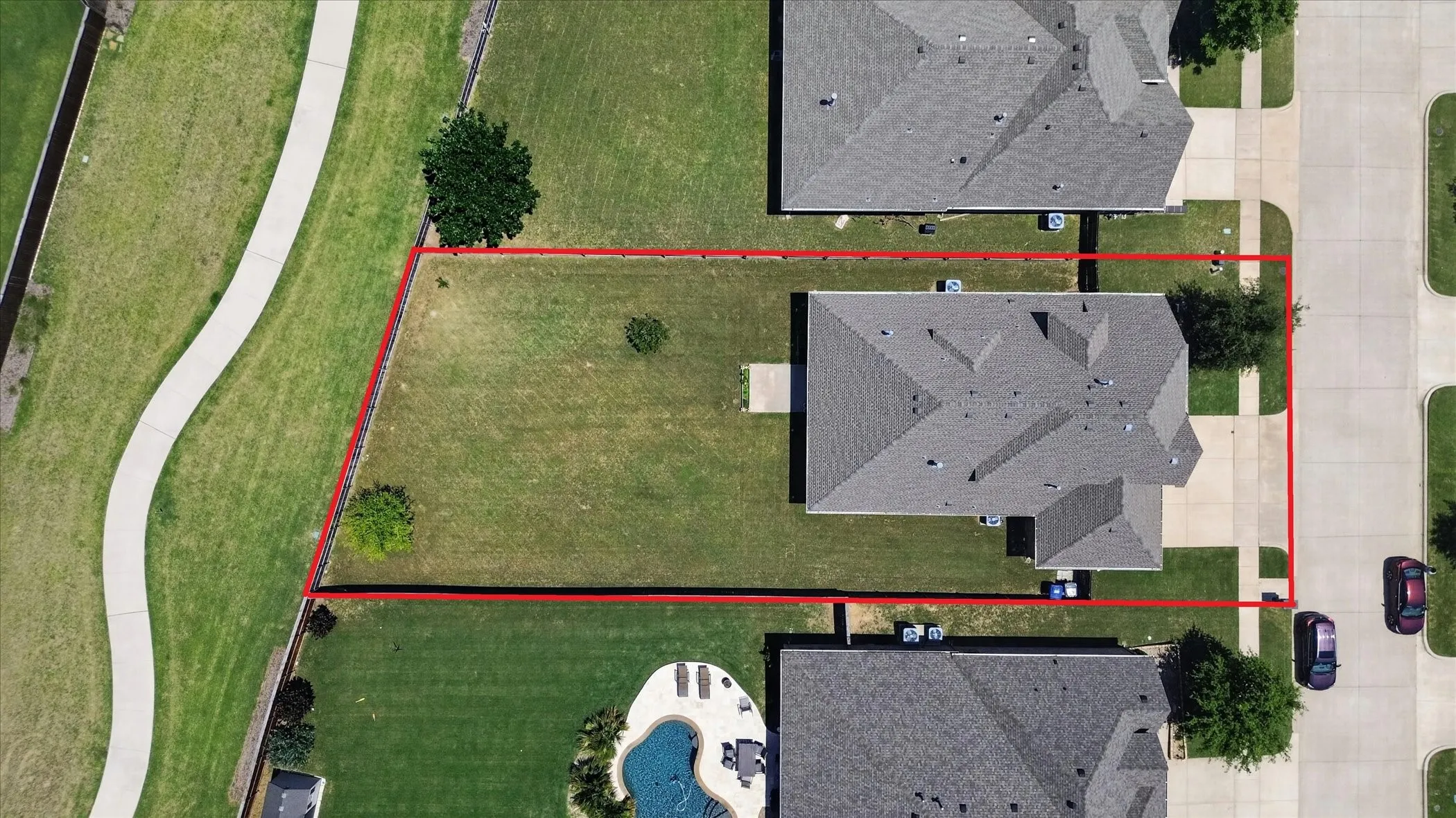 Aerial perspective showcasing a residential property with a defined lot perimeter