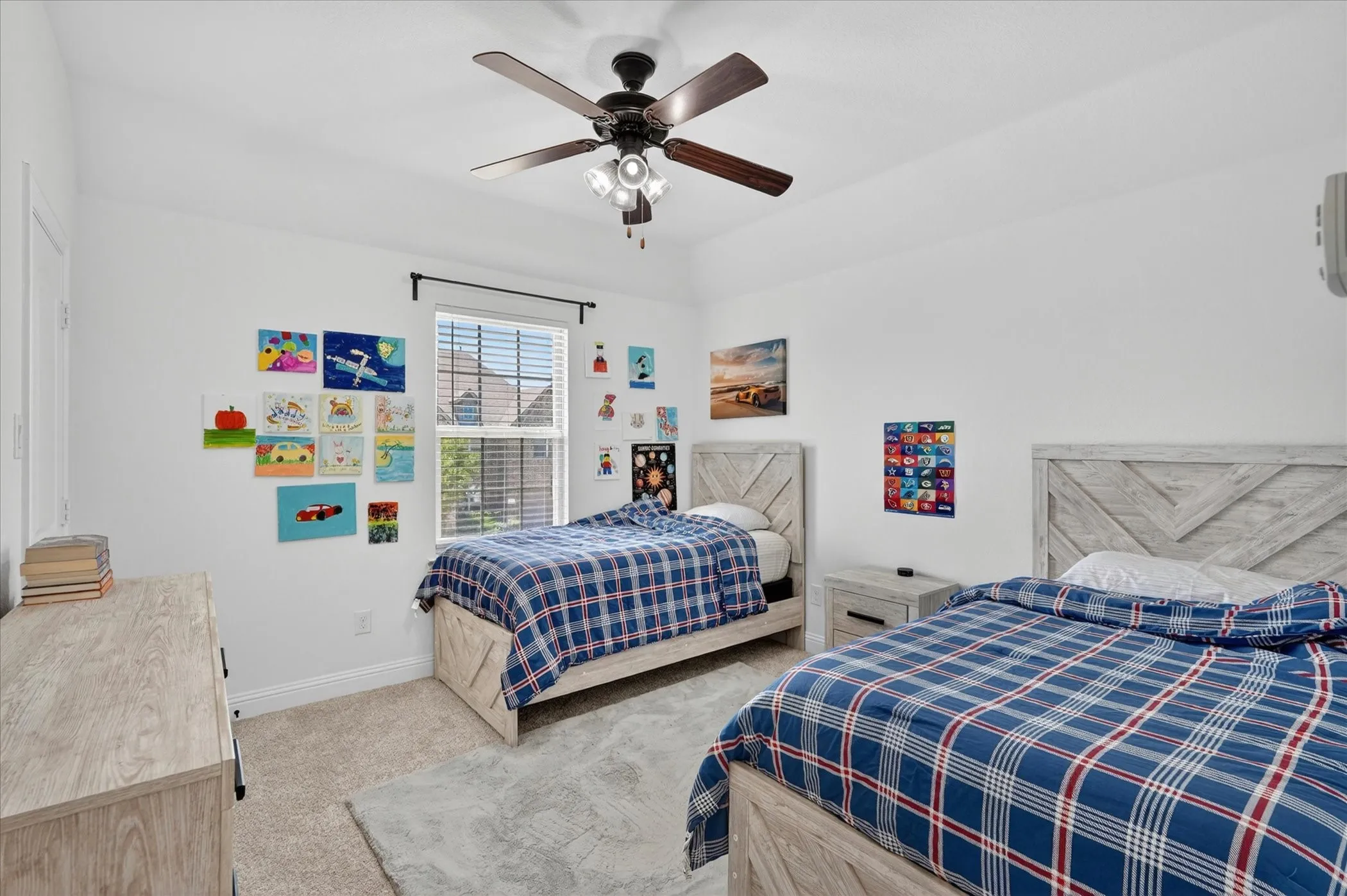 Bright room featuring a window with blinds, a ceiling fan with light fixture, light-toned carpeting, and a built-in closet door