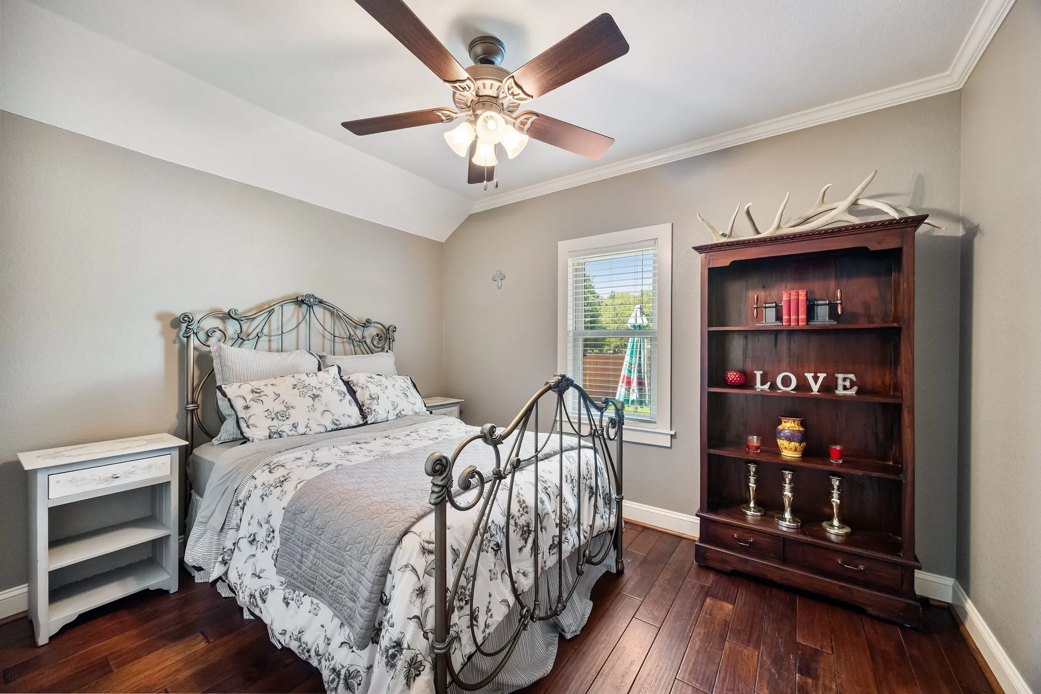 Hardwood-finish flooring extending throughout, complemented by a tray ceiling with crown molding