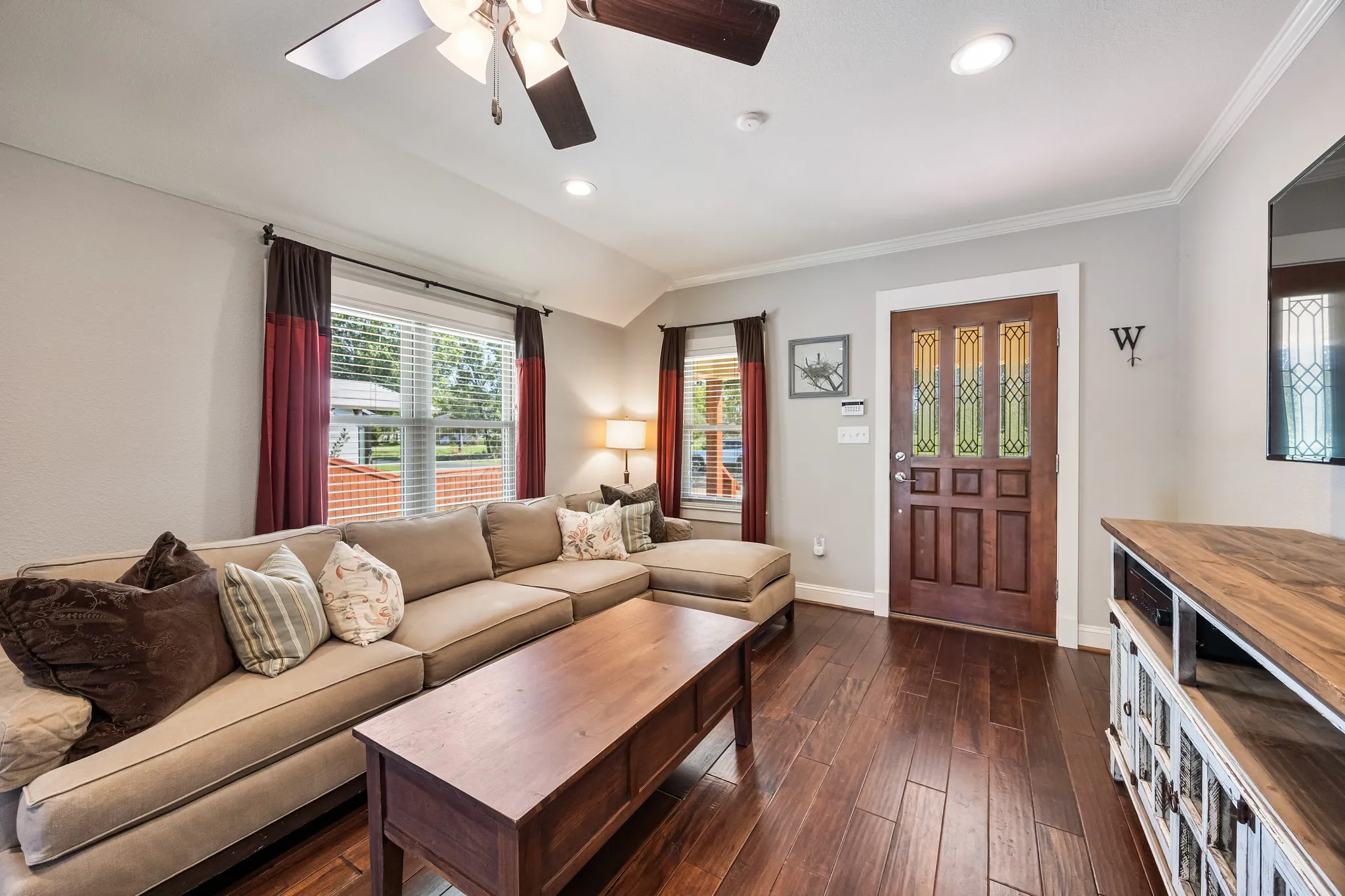 Living area featuring rich wood-finish flooring, recessed lighting, and a ceiling fan