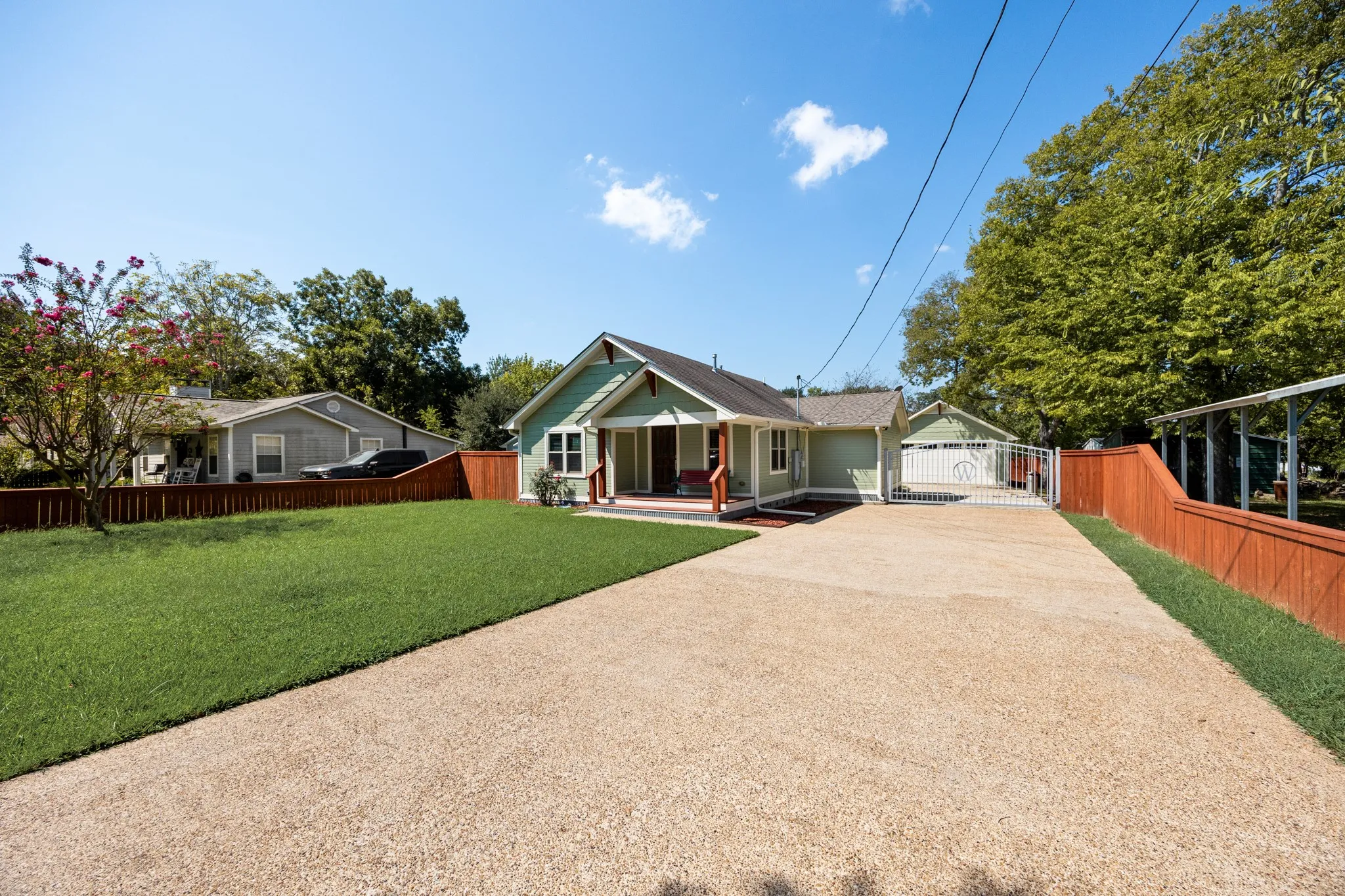 Craftsman-style exterior with a covered front porch and a detached garage