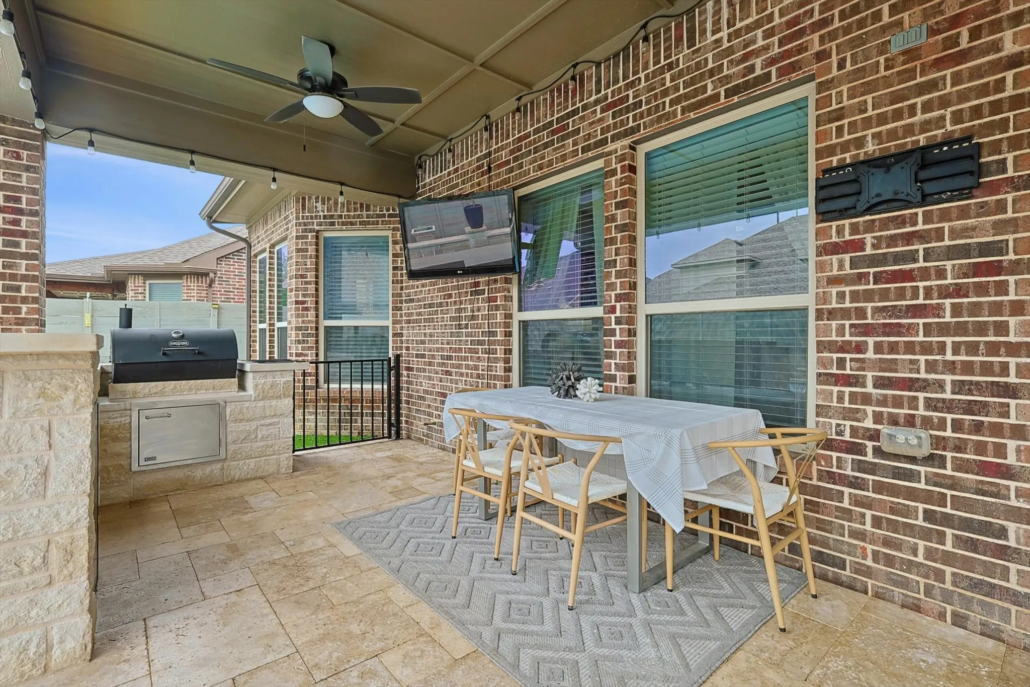 Outdoor living at its best with kitchen, eating area, and lounge space