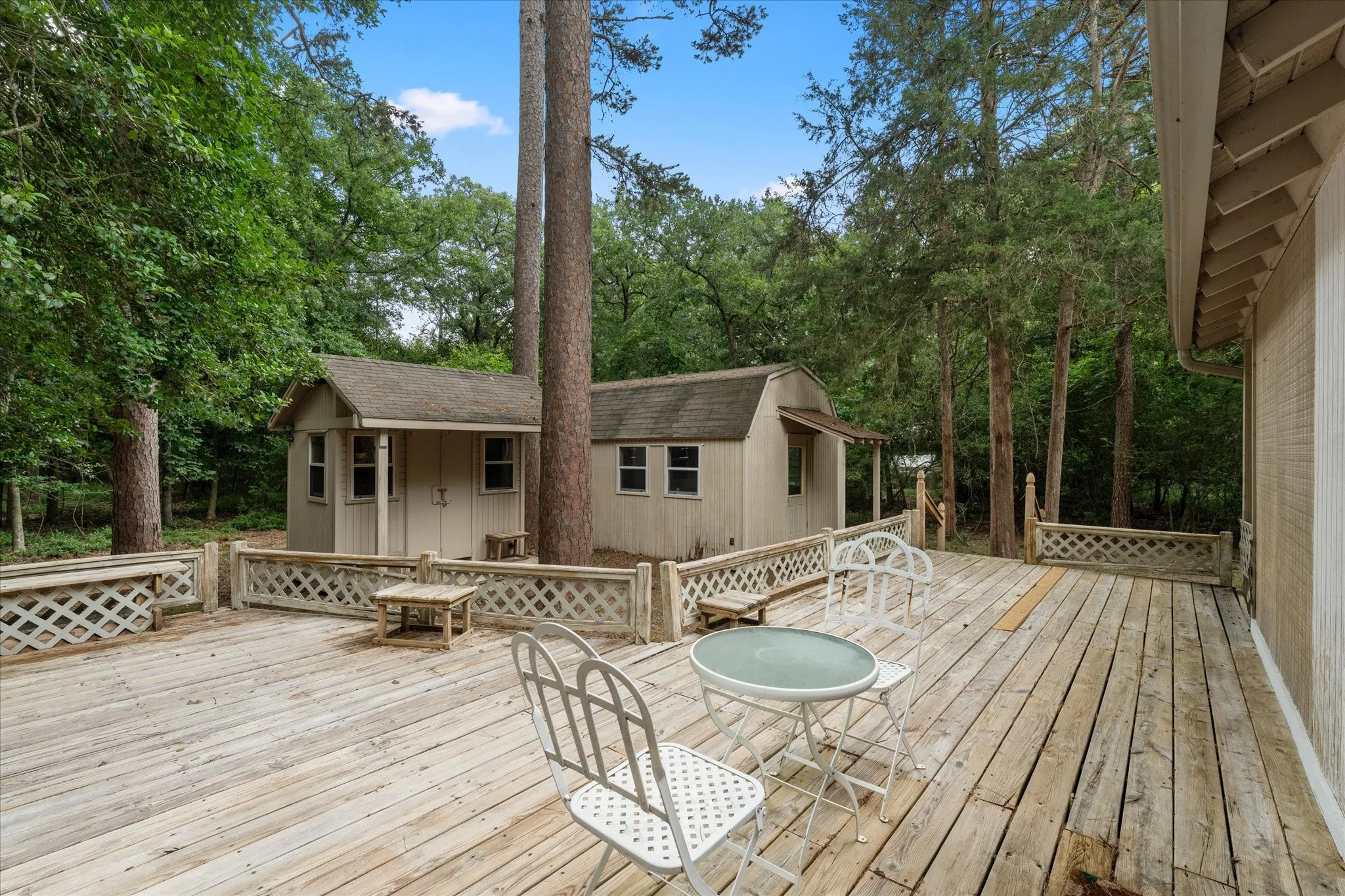 Expansive wooden deck featuring lattice railing and direct access to the main structure