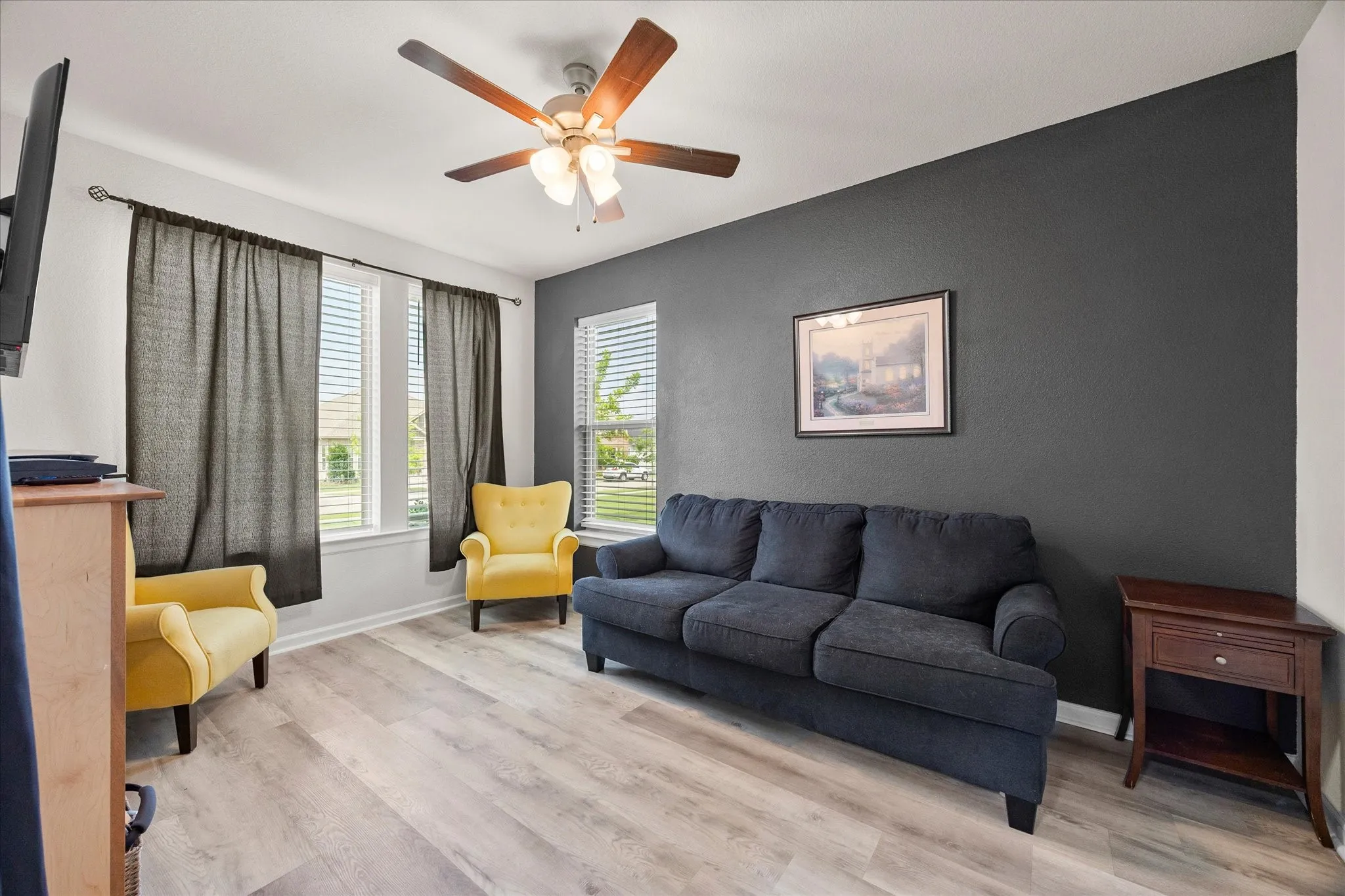 Library/Office Right off the Front Door, flooring, a dark accent wall, and multiple windows with blinds