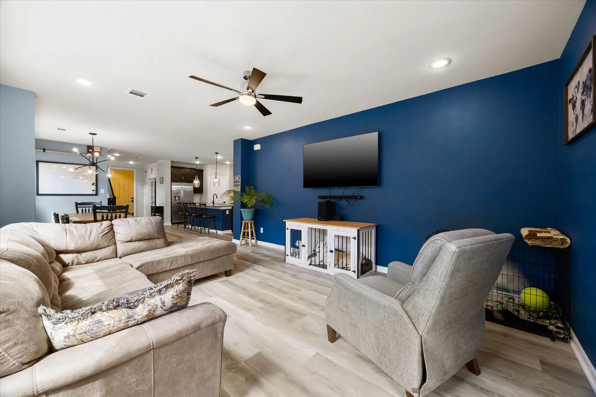 Open-concept living space featuring wood-finish flooring, recessed lighting, and a modern ceiling fan