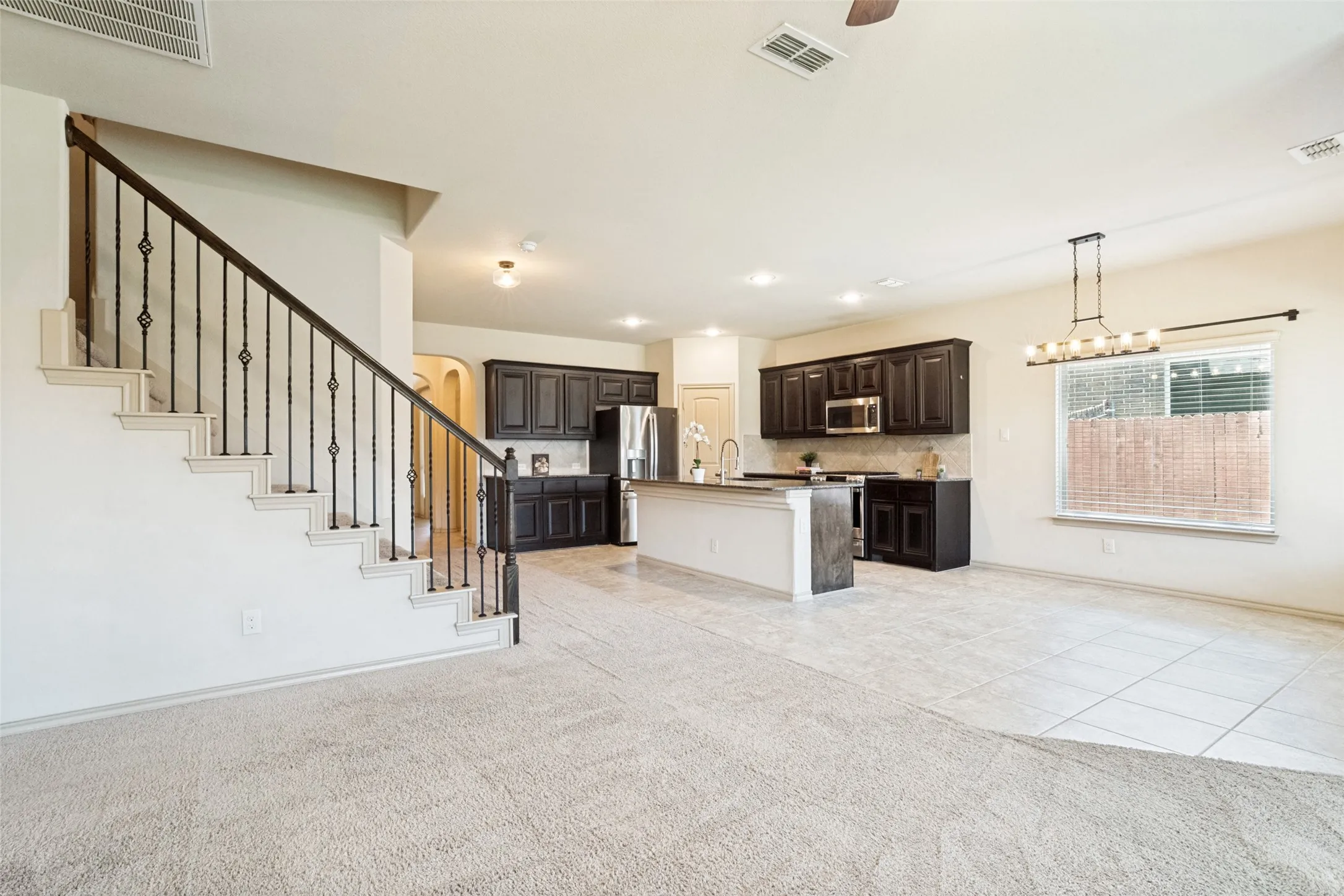 Open concept living and dining with gas fireplace