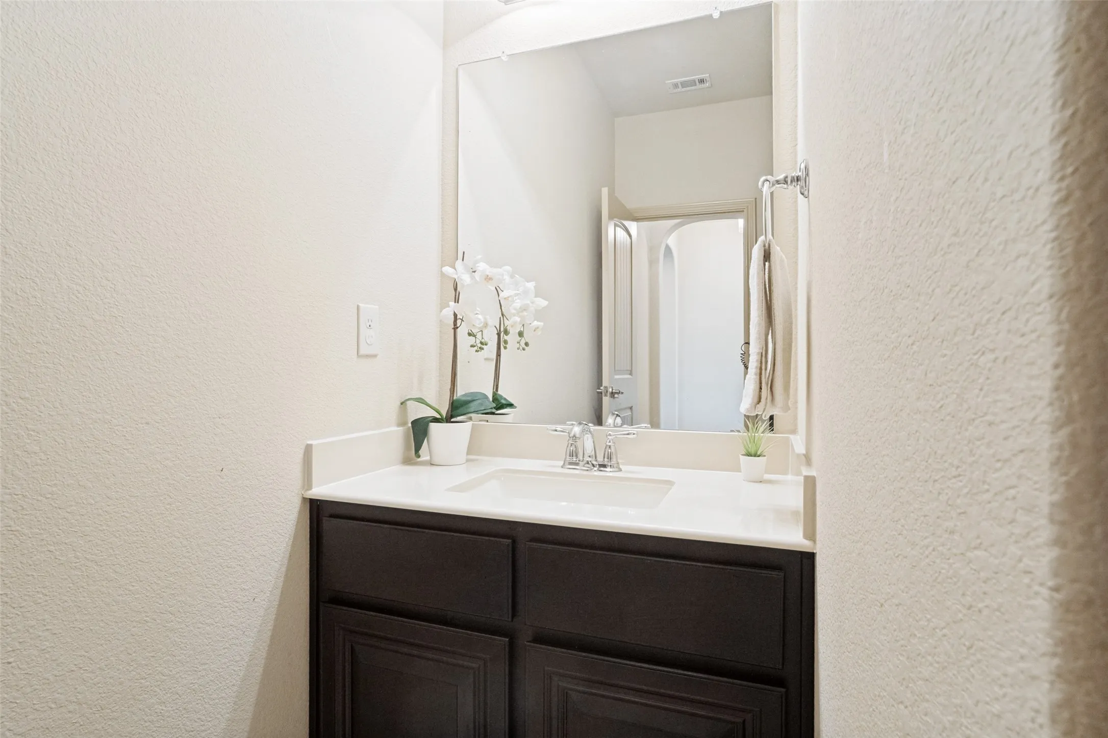 Vanity with a light-toned countertop and an undermount sink