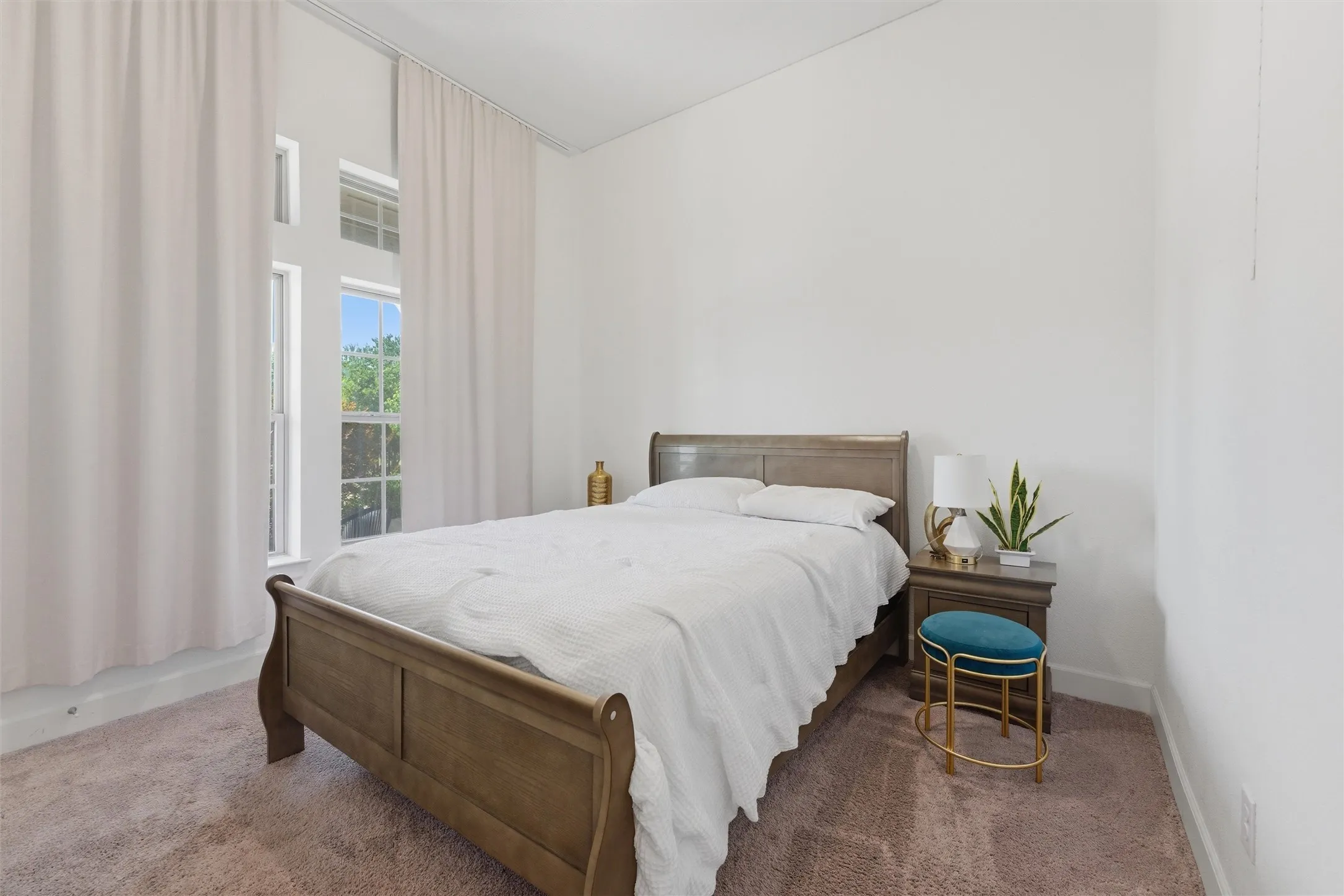 Room featuring light-colored walls and soft carpet flooring