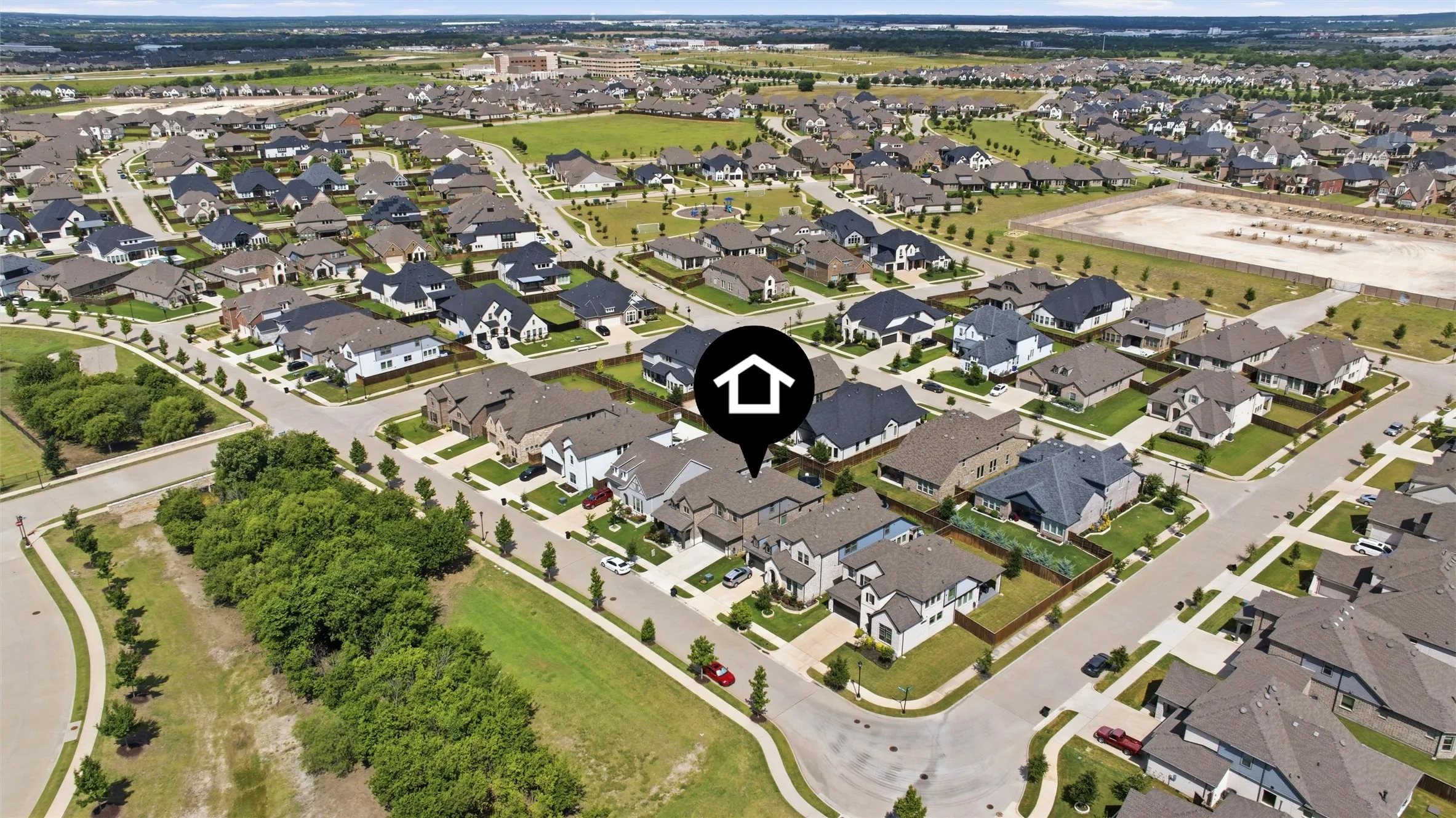 Aerial perspective of a developed residential community featuring a network of streets and uniform lot sizes