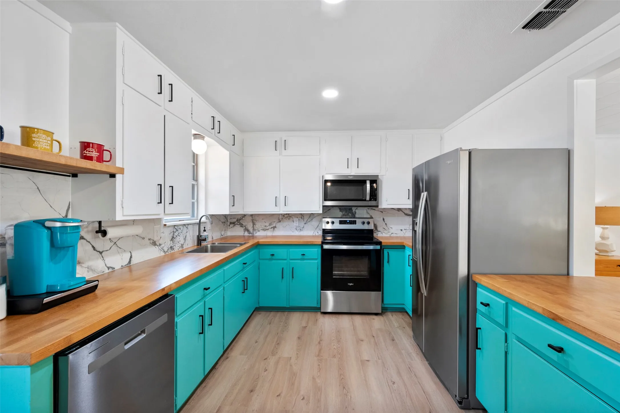 Large galley kitchen with stainless steel appliances