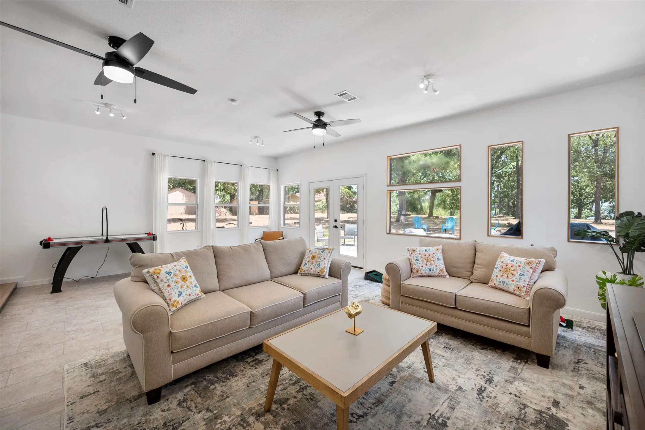 large entertainment game room with lots of windows to see the water view