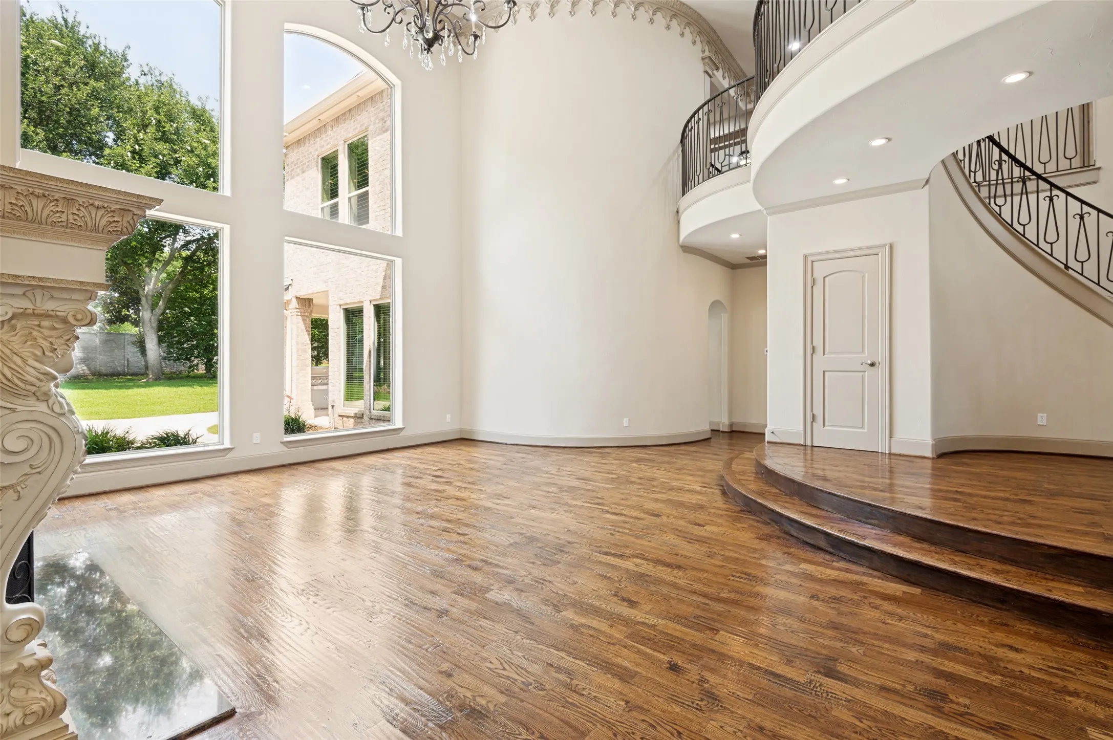 View of living from entrance to the primary bedroom. Main entry is located off to the right. Entrance to the family areas just left of paneled door. What a satisfying view to welcome each morning!
