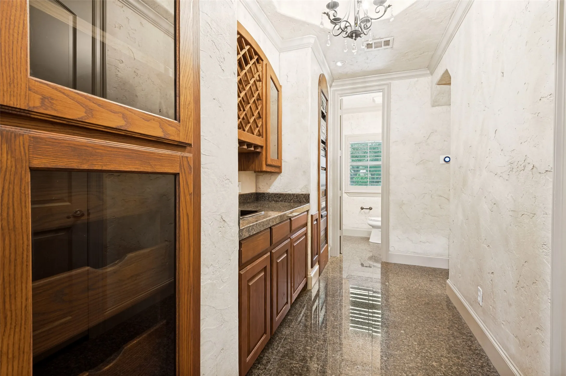 Refreshment center and built in equipment shelves for media room. Half bath end of hall.