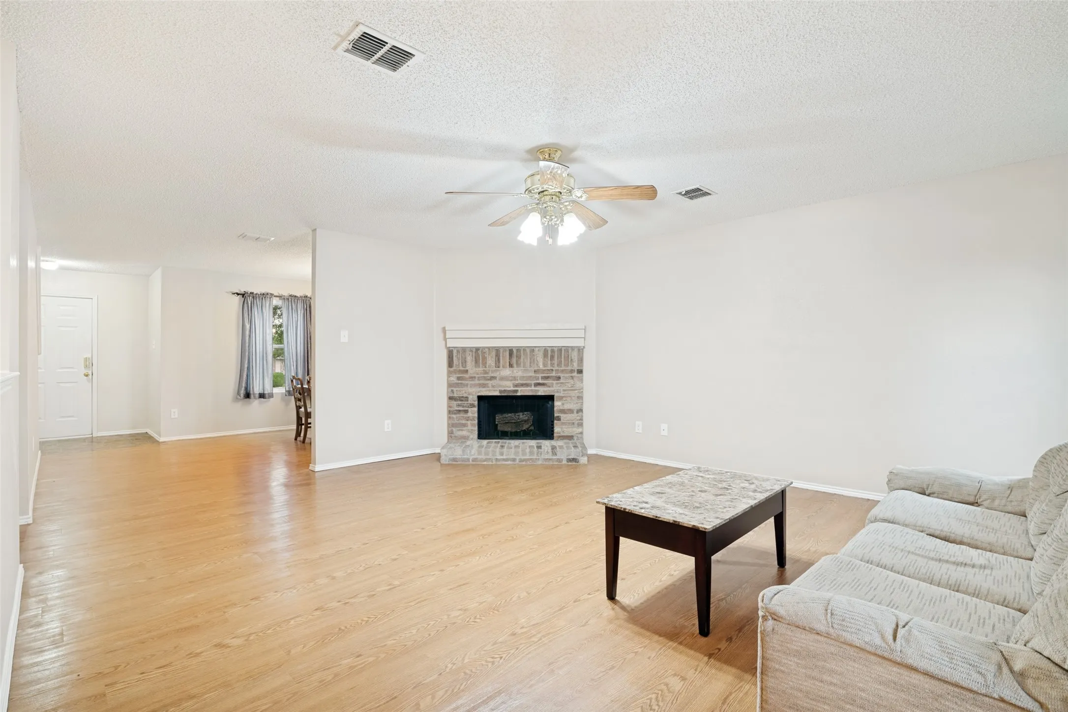 Living room with wood burning fireplace.