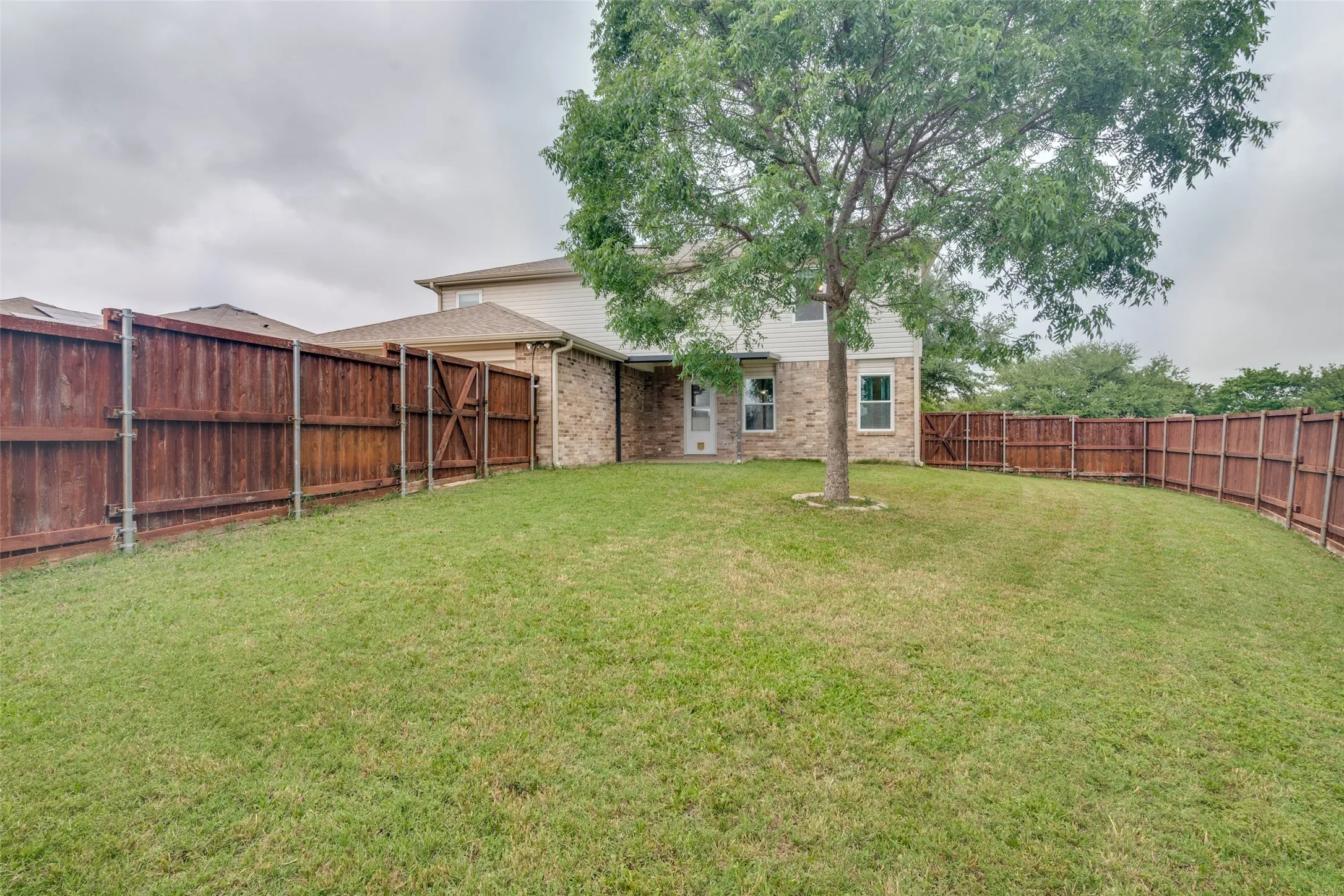 Large backyard with covered patio