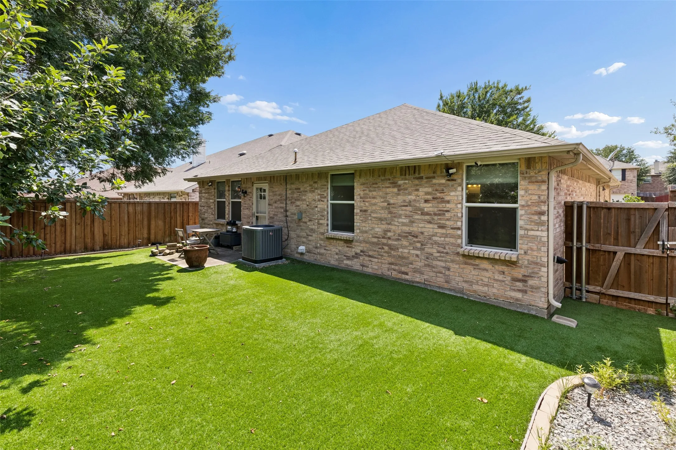 Spacious, low maintenance backyard with turf installed in 2022.